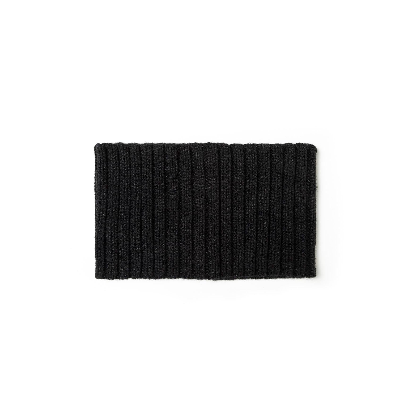 Flat lay of black ribbed knit snood showing the tubular construction and ribbed texture pattern against white background