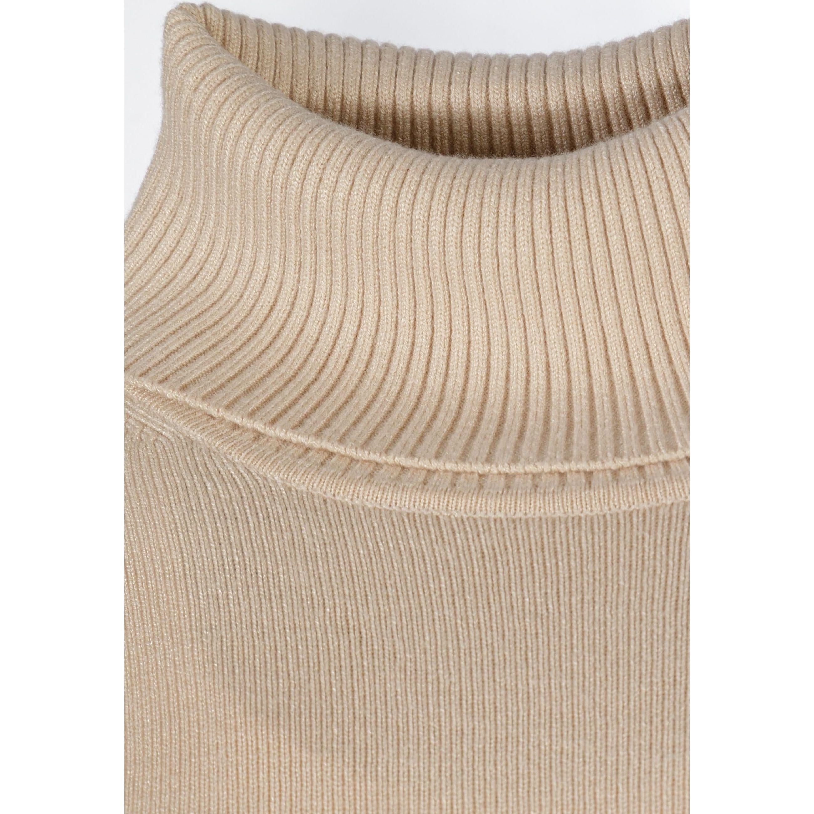 Close-up detail of beige turtleneck collar showing ribbed knit texture and folded design on white background