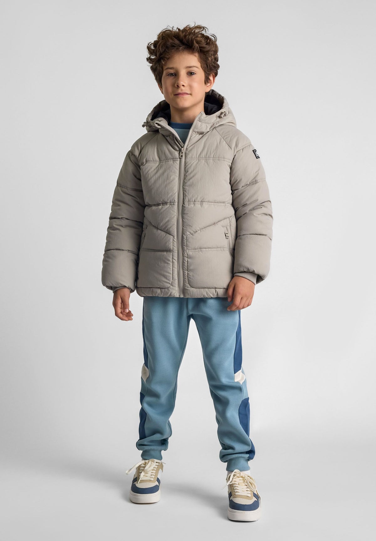 Boys' stone puffer jacket, shown worn.