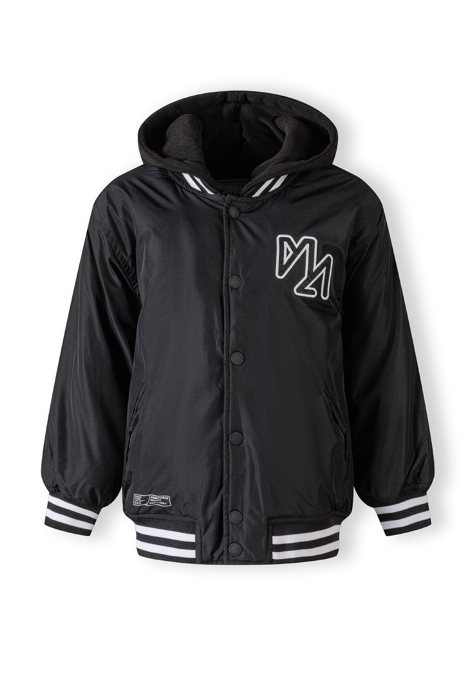 Boys baseball style jacket in black, front view with detachable hood and striped cuffs.