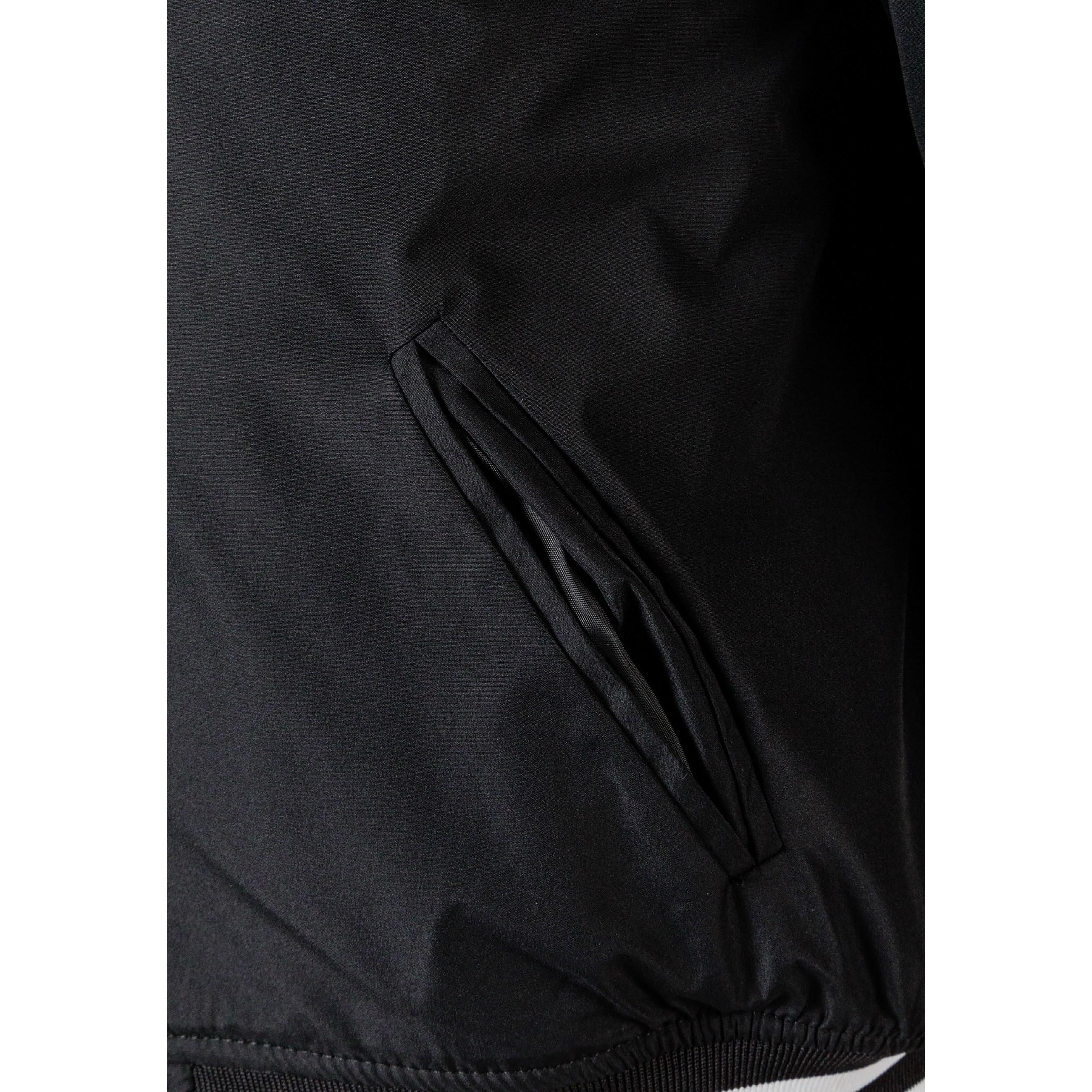Flat lay of black baseball jacket with detachable hood showing snap button front closure and contrasting white striped ribbed cuffs and waistband