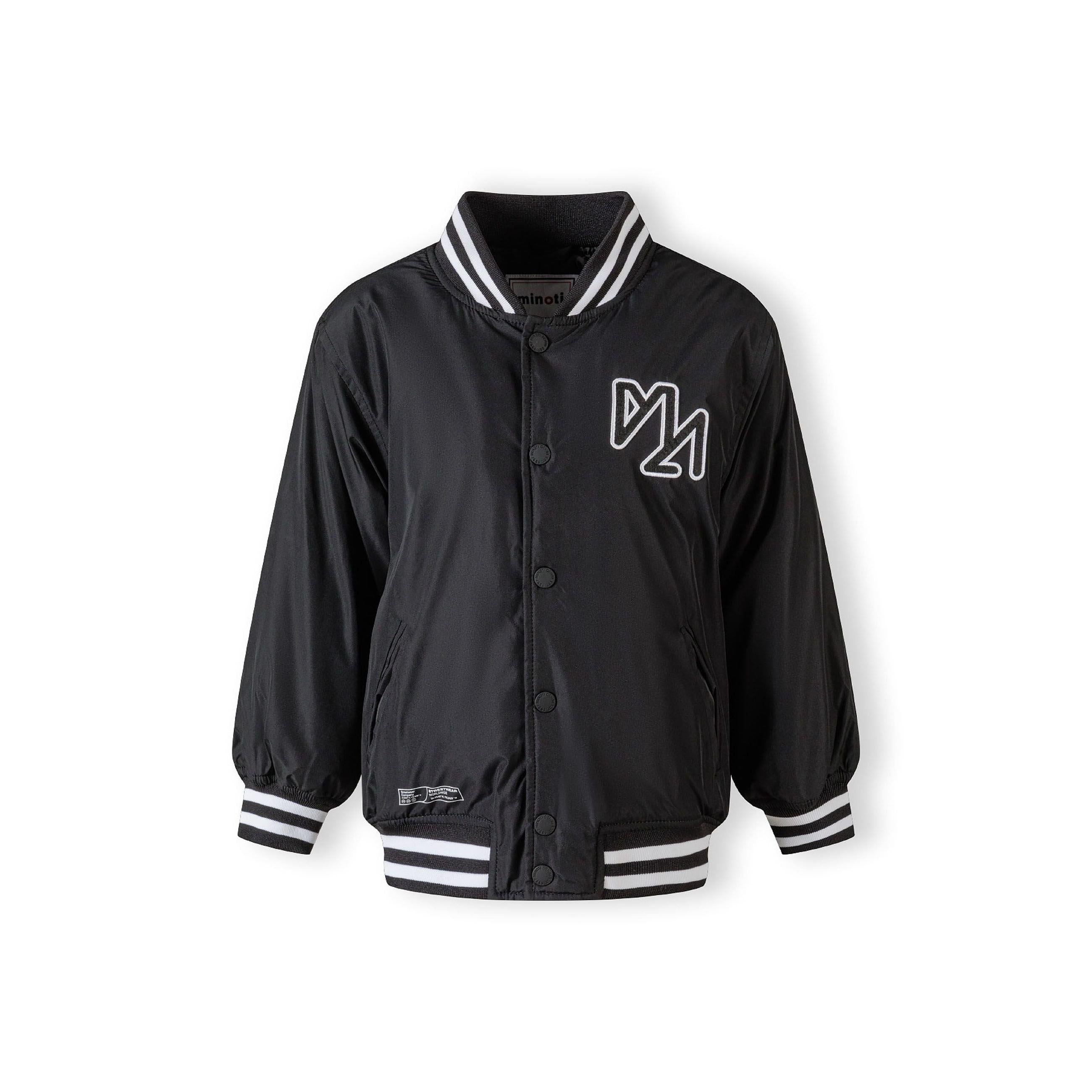 Flat lay of black baseball jacket with detachable hood showing snap button front closure and contrasting white striped ribbed cuffs and waistband