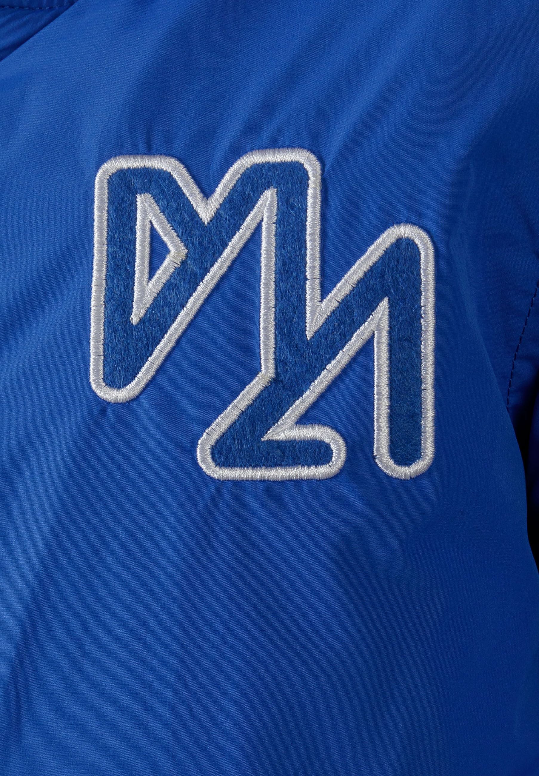 Detail of boys baseball jacket in cobalt blue with embroidered logo.
