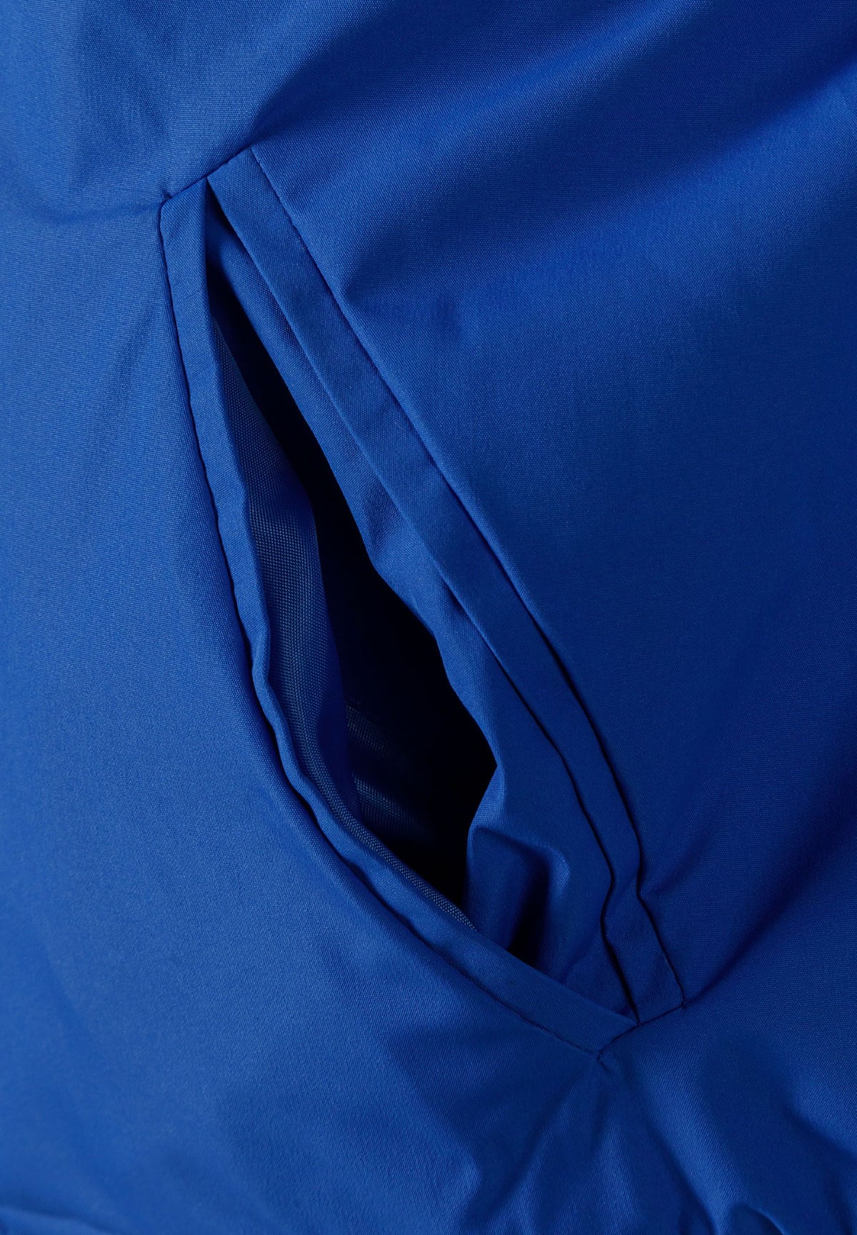 Close-up of the pocket on the blue varsity jacket.