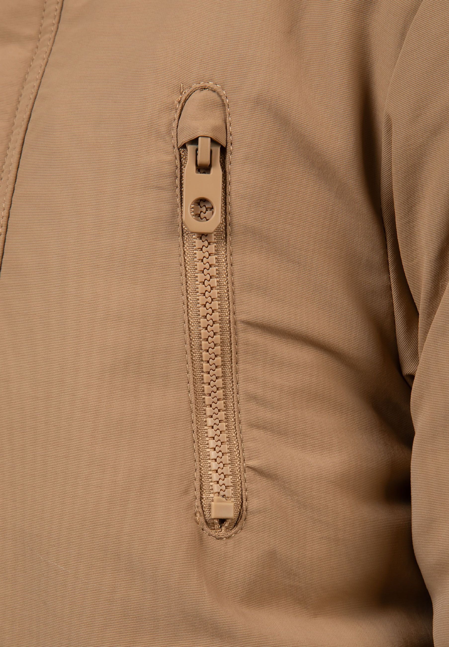 Detail of a beige boys winter parka featuring a zippered pocket.