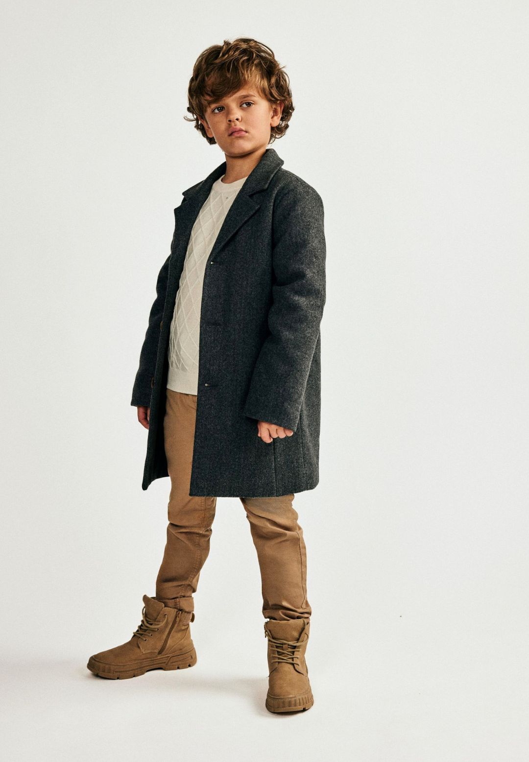 Boys grey smart coat, front view with mock horn buttons and seam pockets.