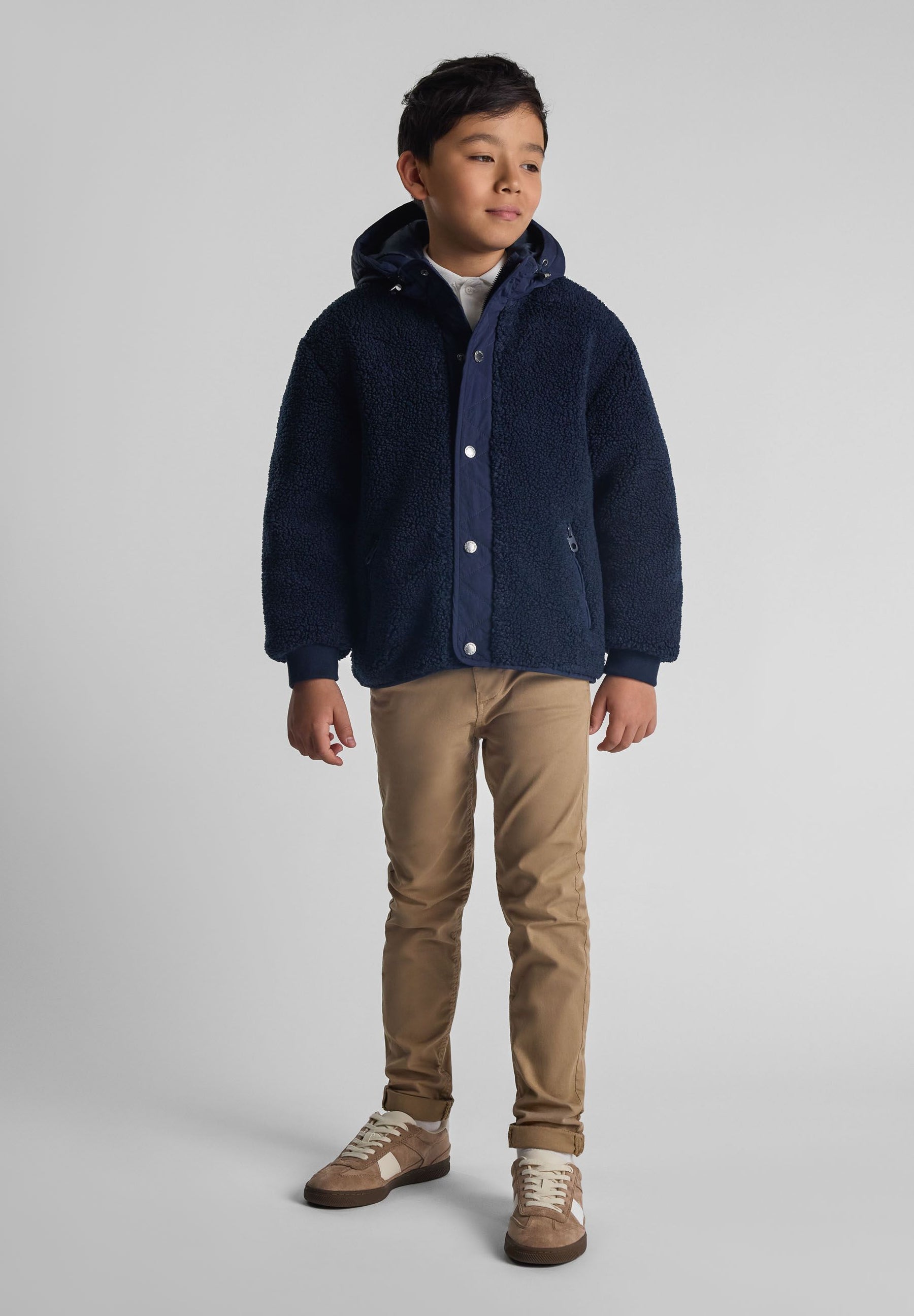 Boys padded borg jacket in navy, front view with triple fastening and hood.