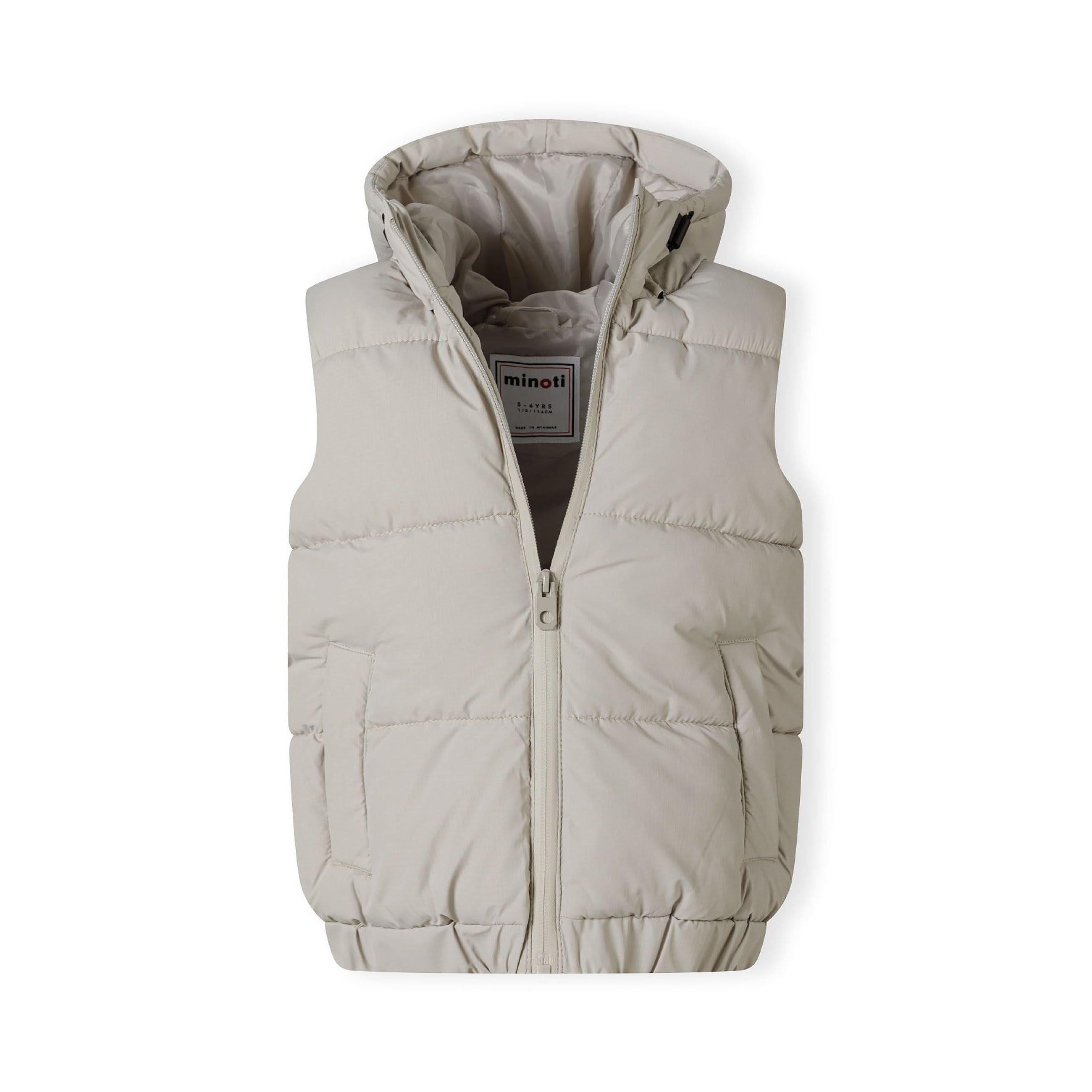 Close-up detail of grey padded gilet showing zip pocket construction and quilted fabric texture