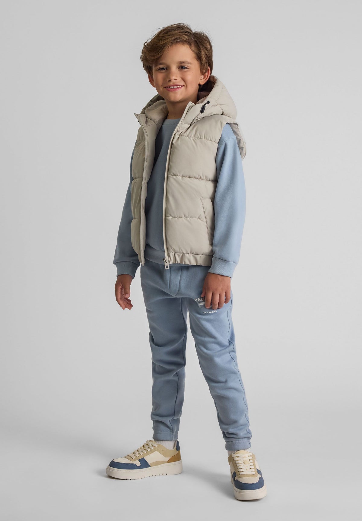 Light grey padded gilet, model front.