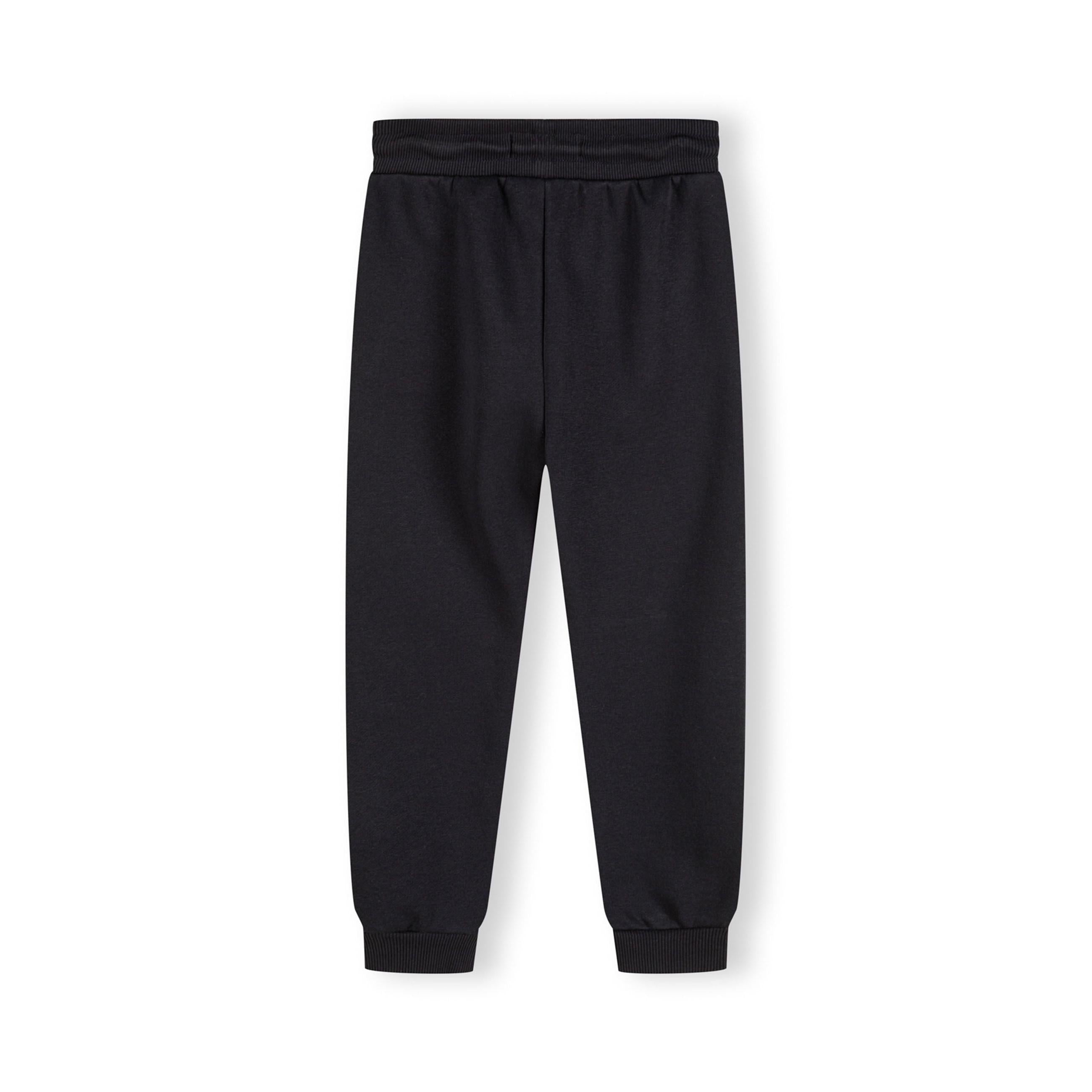 Back view of grey children's sweatpants laid flat showing ribbed waistband, back seam detail and ankle cuffs against white background