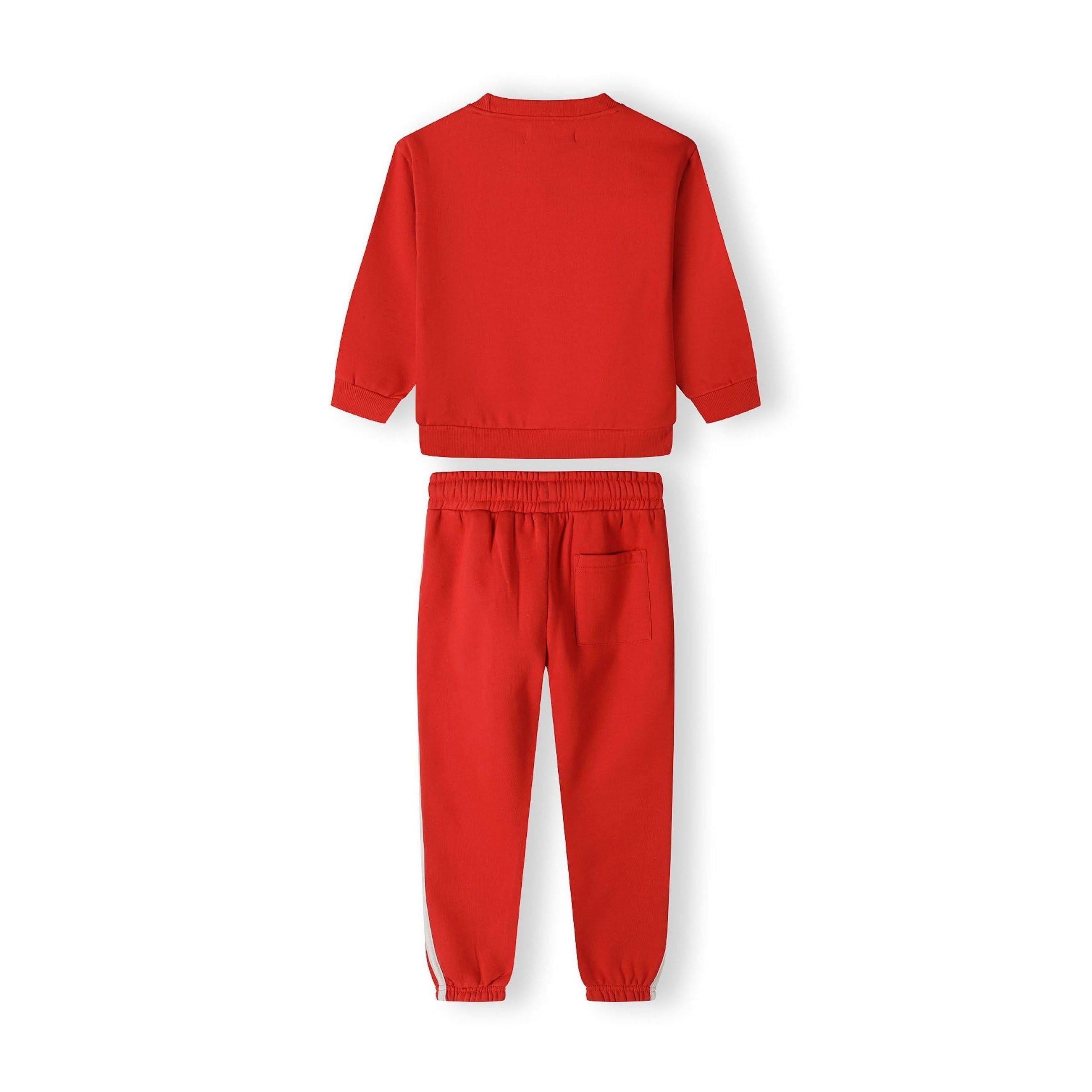 Close-up detail of red joggers showing white drawstring ties and front pocket construction