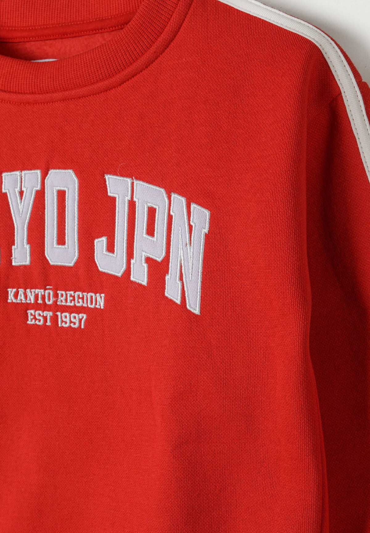Red and cream sweatshirt and joggers set, chest and sleeve stripe detail.