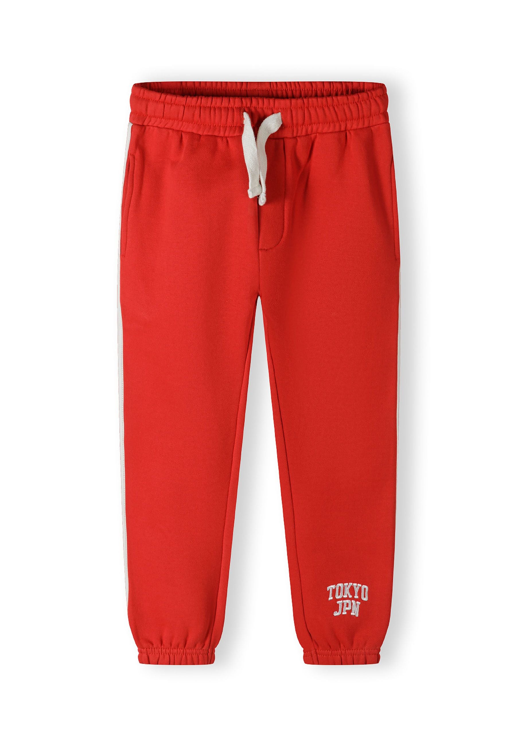 Red joggers with elastic waistband, side pockets, and 'TOKYO JPN' print.
