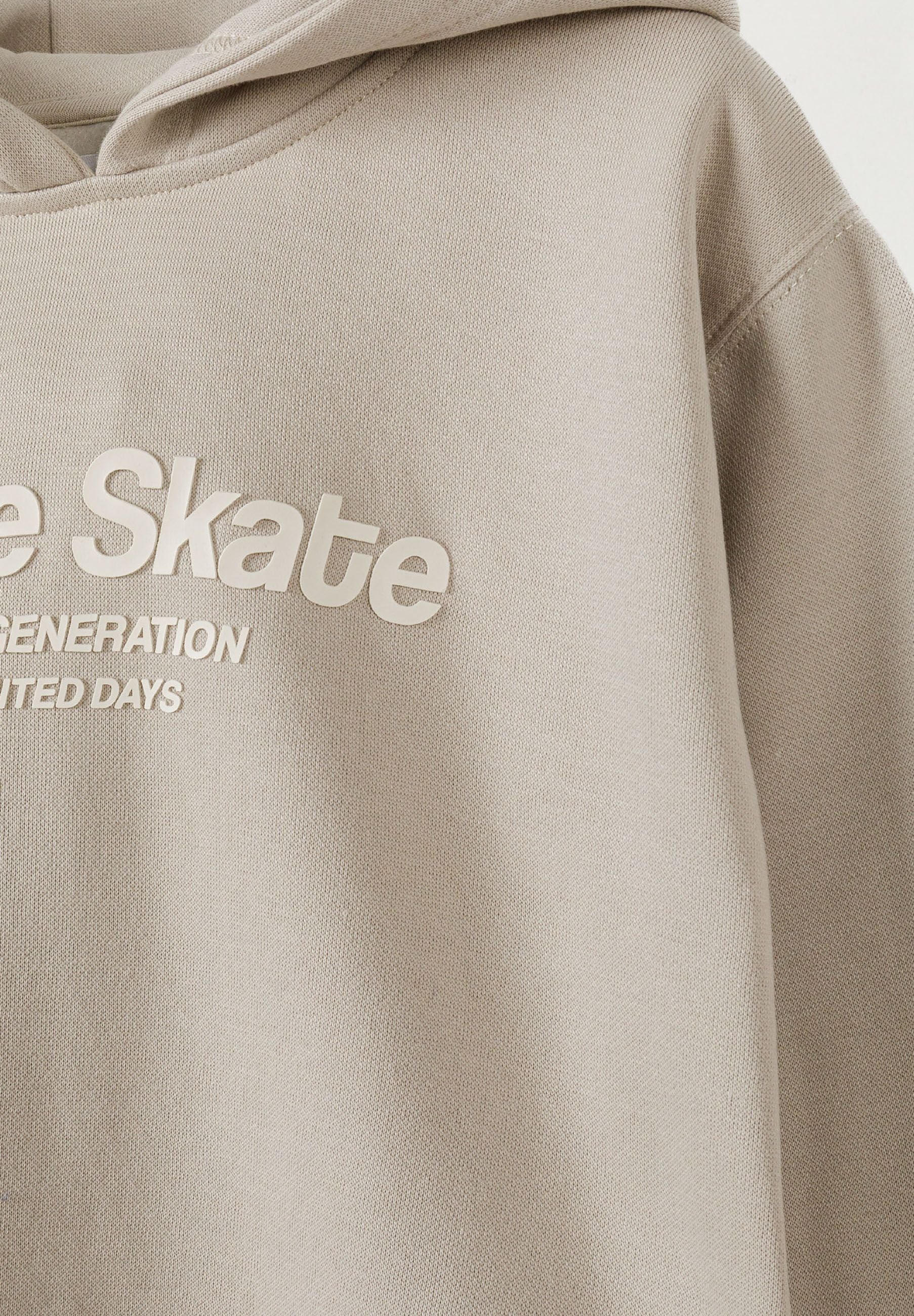 Detail of boys hoodie with raised rubber 'future skate' print on the chest.