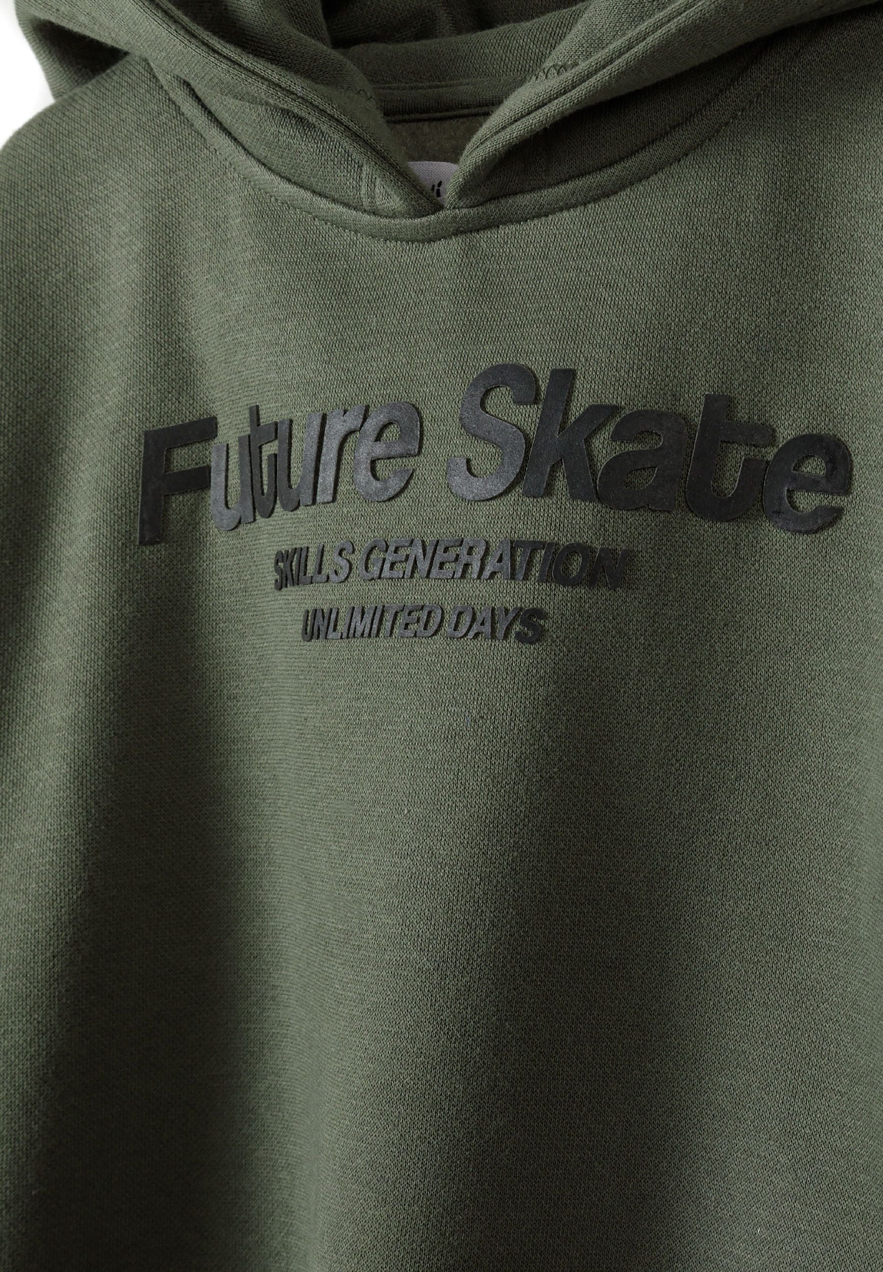 Close-up of khaki hoodie featuring 'Future Skate' rubber print on the chest.