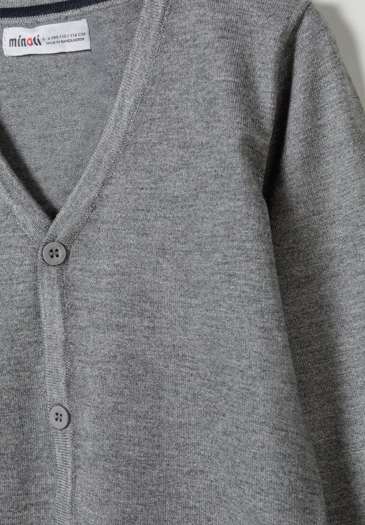 Close-up of heather grey cardigan showing ribbed V-neck and matching four-hole buttons.