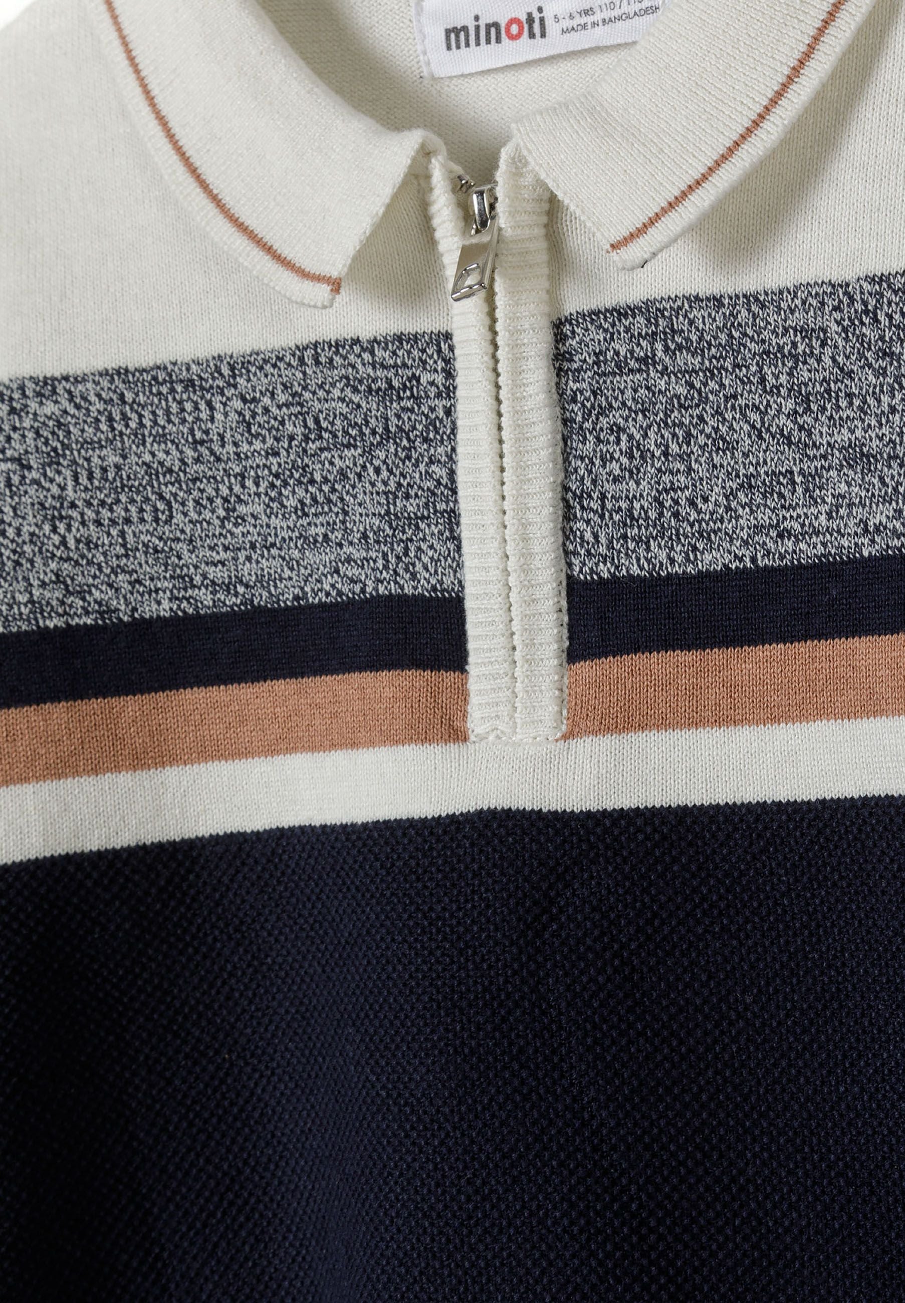 Close-up of a boys' cream polo-style sweater with a quarter zip and striped detailing.