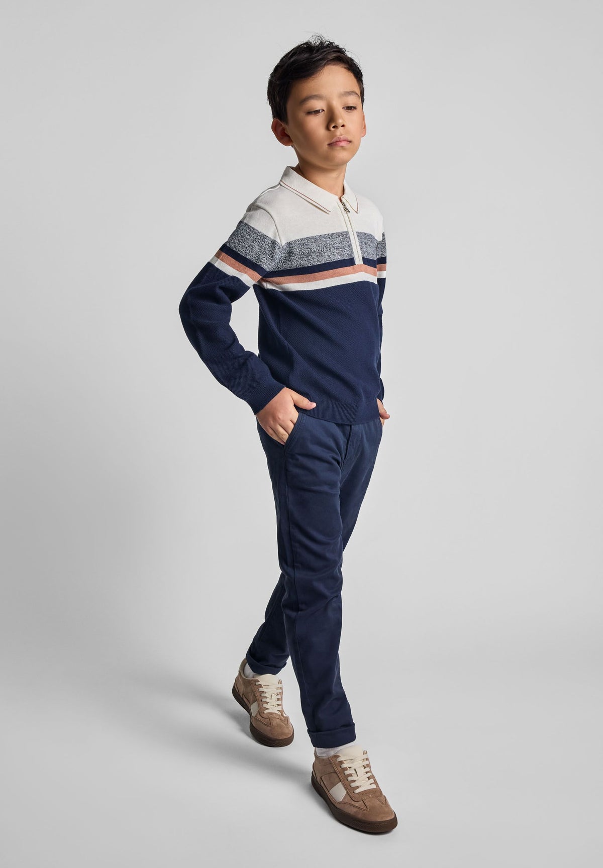 Navy, cream, grey and brown quarter-zip collared jumper, model front.