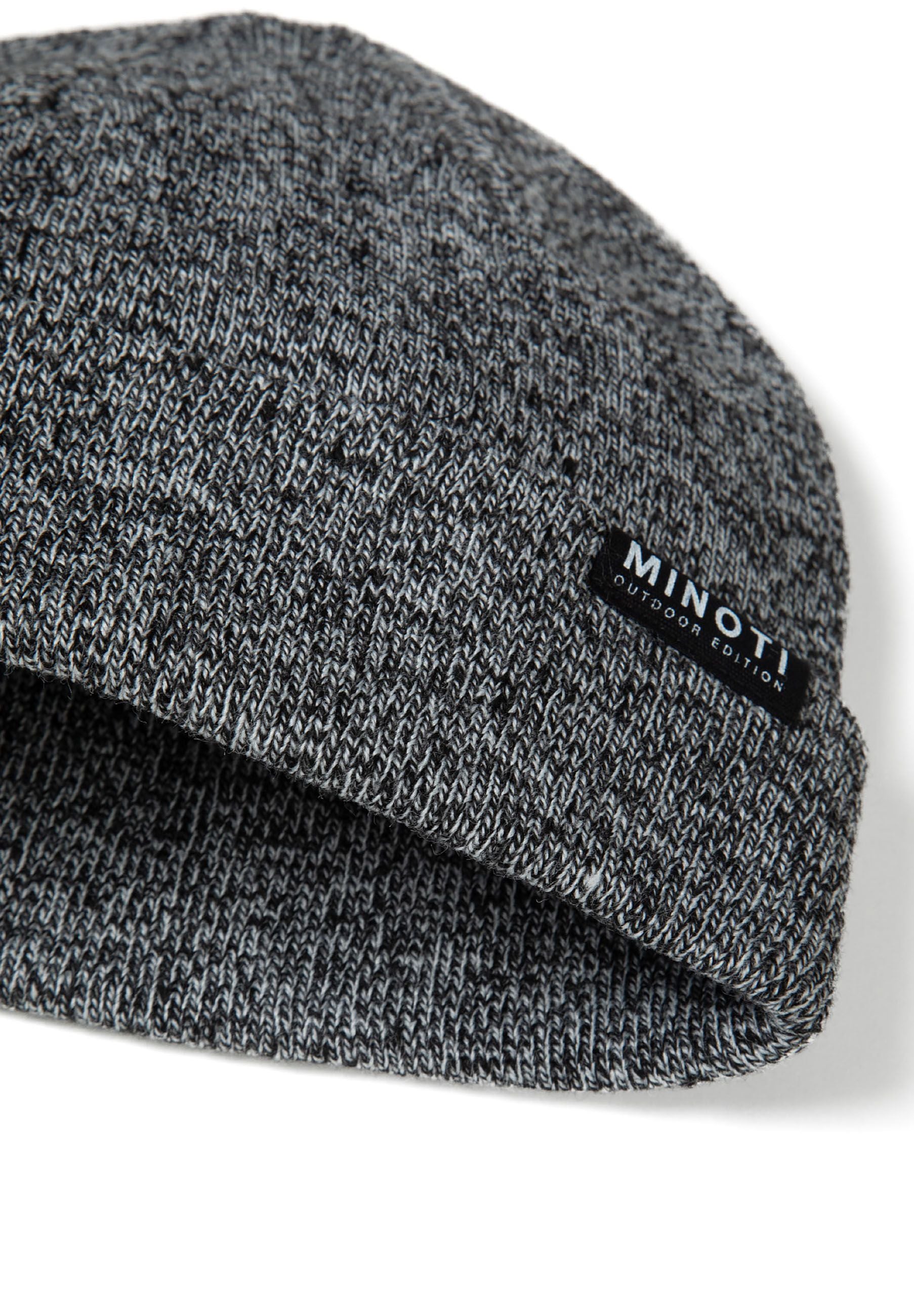 Detail of a grey knitted beanie with a ribbed cuff and badge.