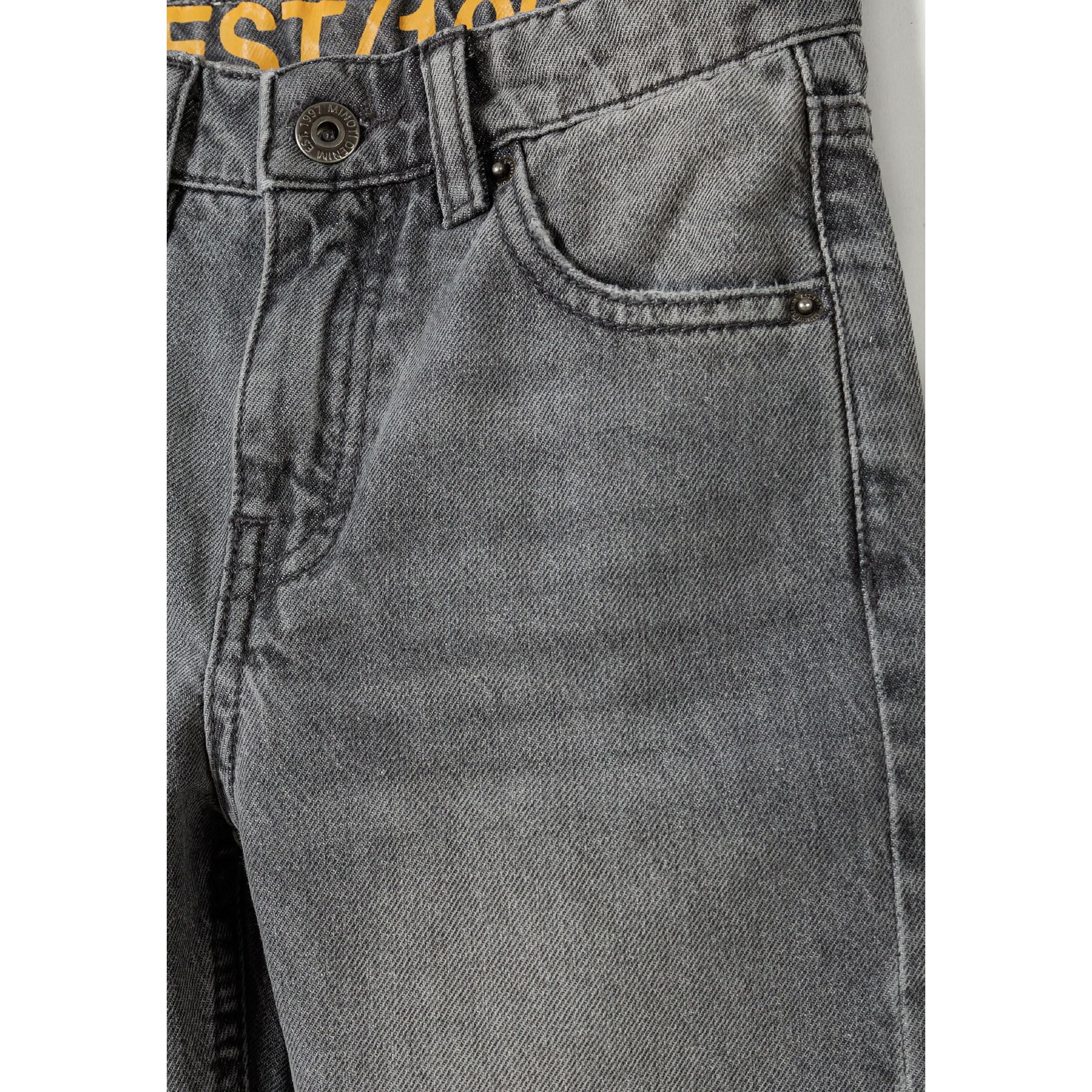 Close-up detail of grey denim showing rip and repair distressing on front pocket area and thigh, highlighting the contemporary worn-in aesthetic