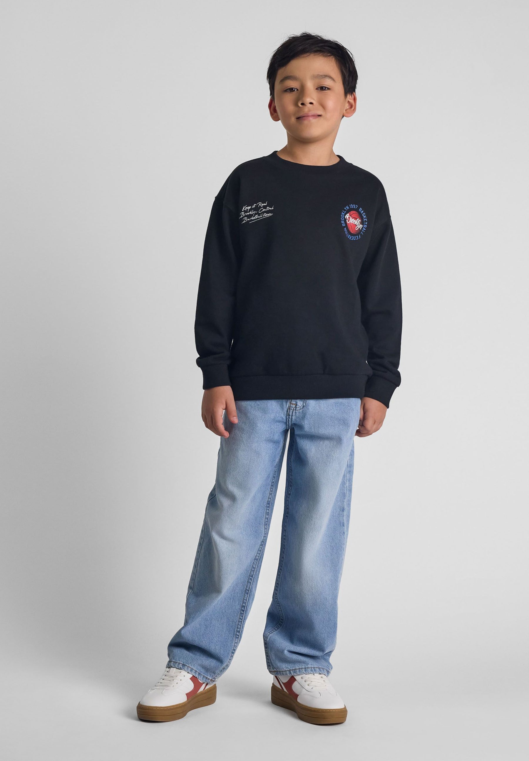Boys baggy fit denim jeans in light blue, front view with five-pocket design.