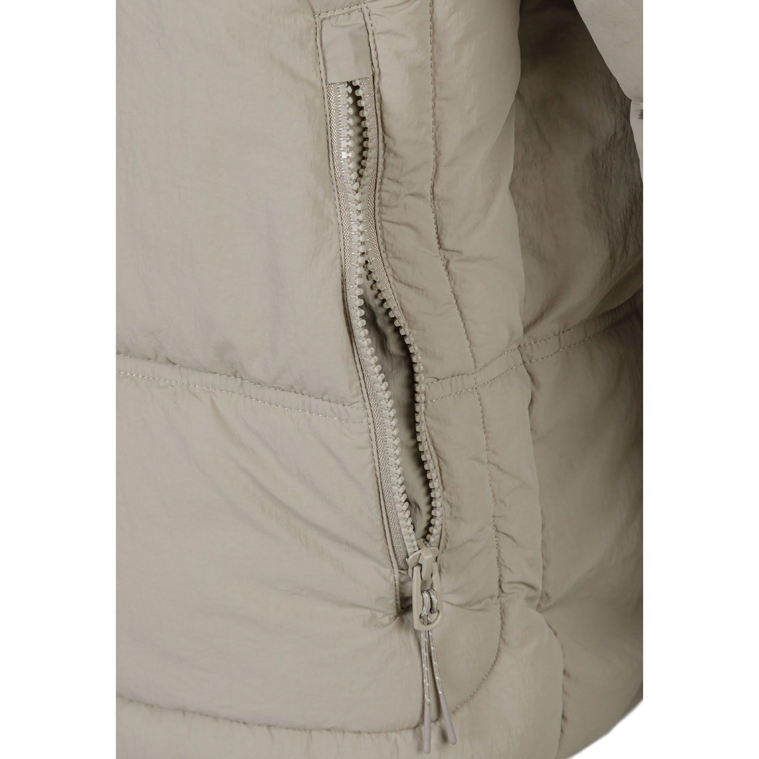 Close-up detail of grey quilted fabric showing black rectangular RESPECT logo patch with white text on jacket arm