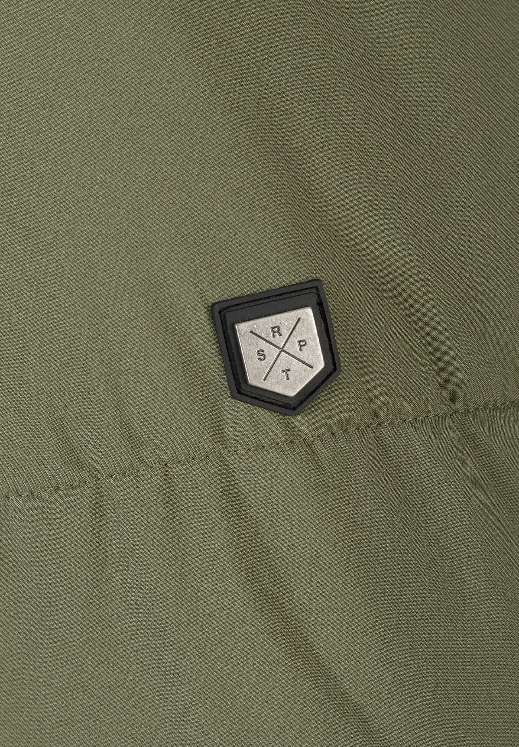 Detail of khaki jacket showing logo badge.