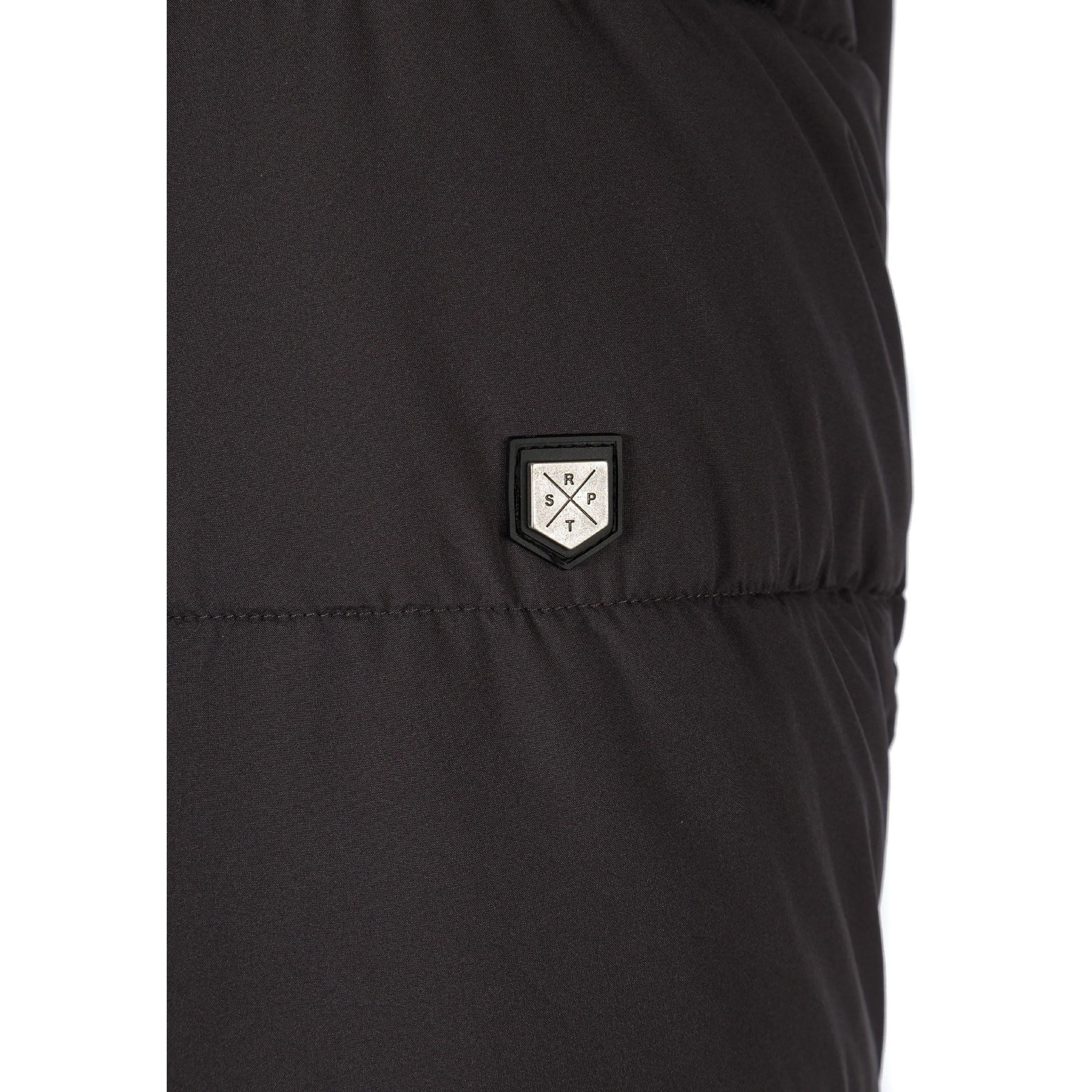 Close-up detail of grey padded jacket showing quilted pattern and small branded label patch