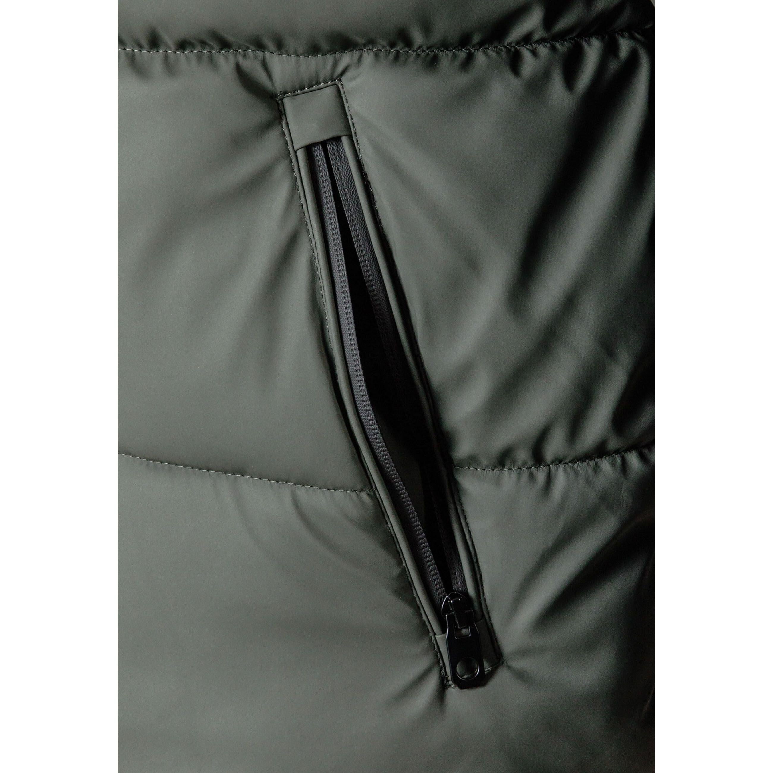 Close-up detail of zip pocket with black zipper on khaki padded jacket fabric