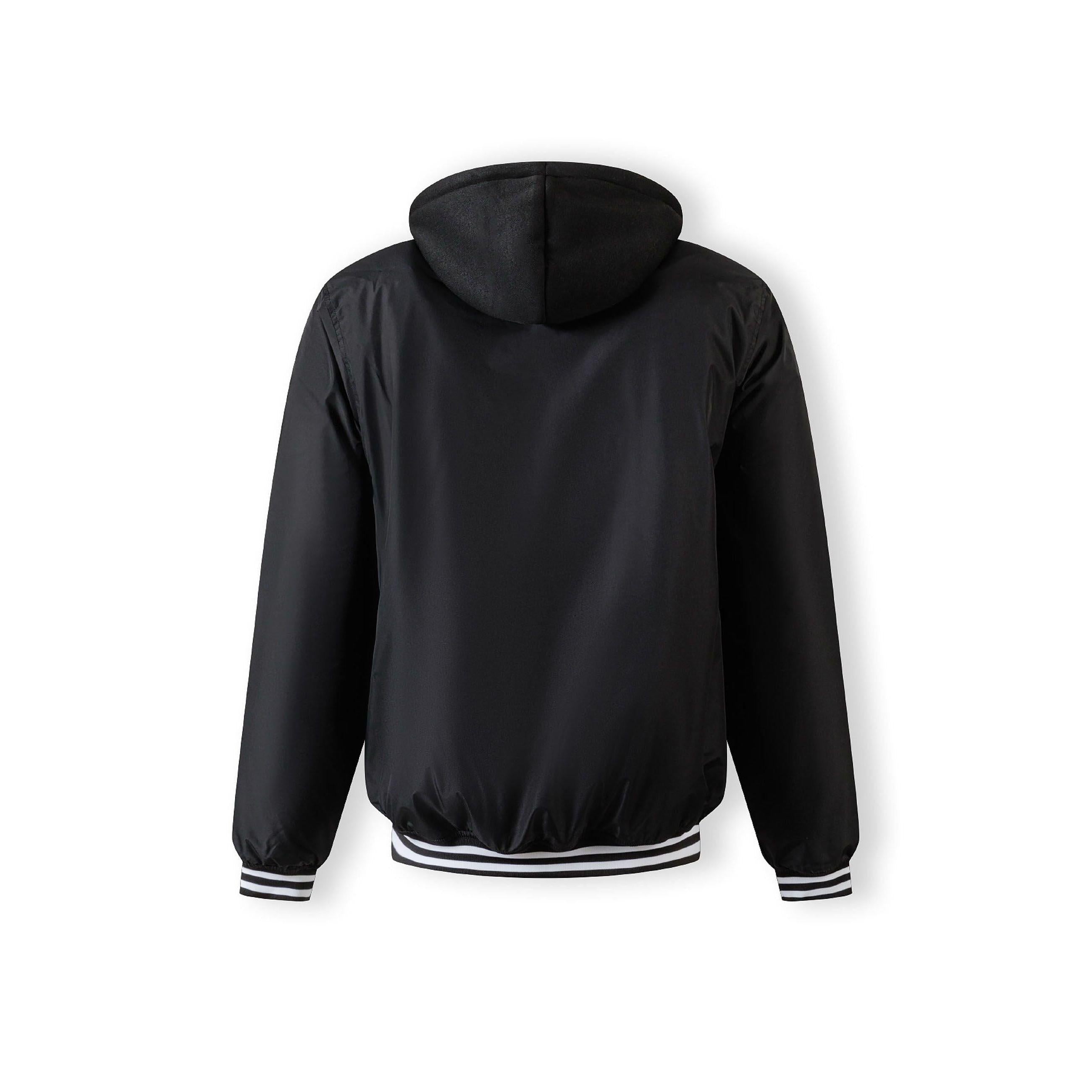 Close-up detail of black jacket showing zip closure with press studs and fabric texture