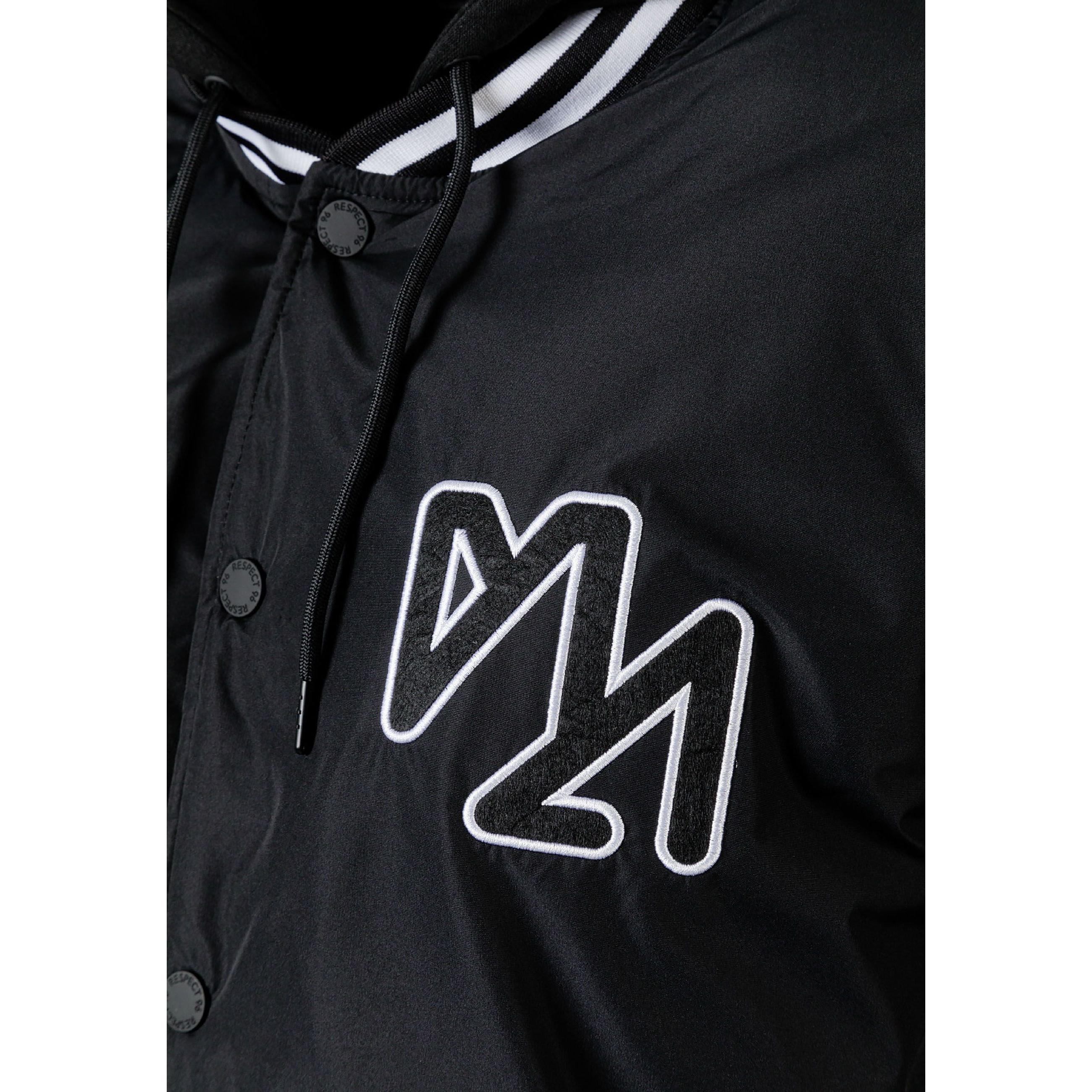 Close-up detail of black jacket showing zip closure with press studs and fabric texture