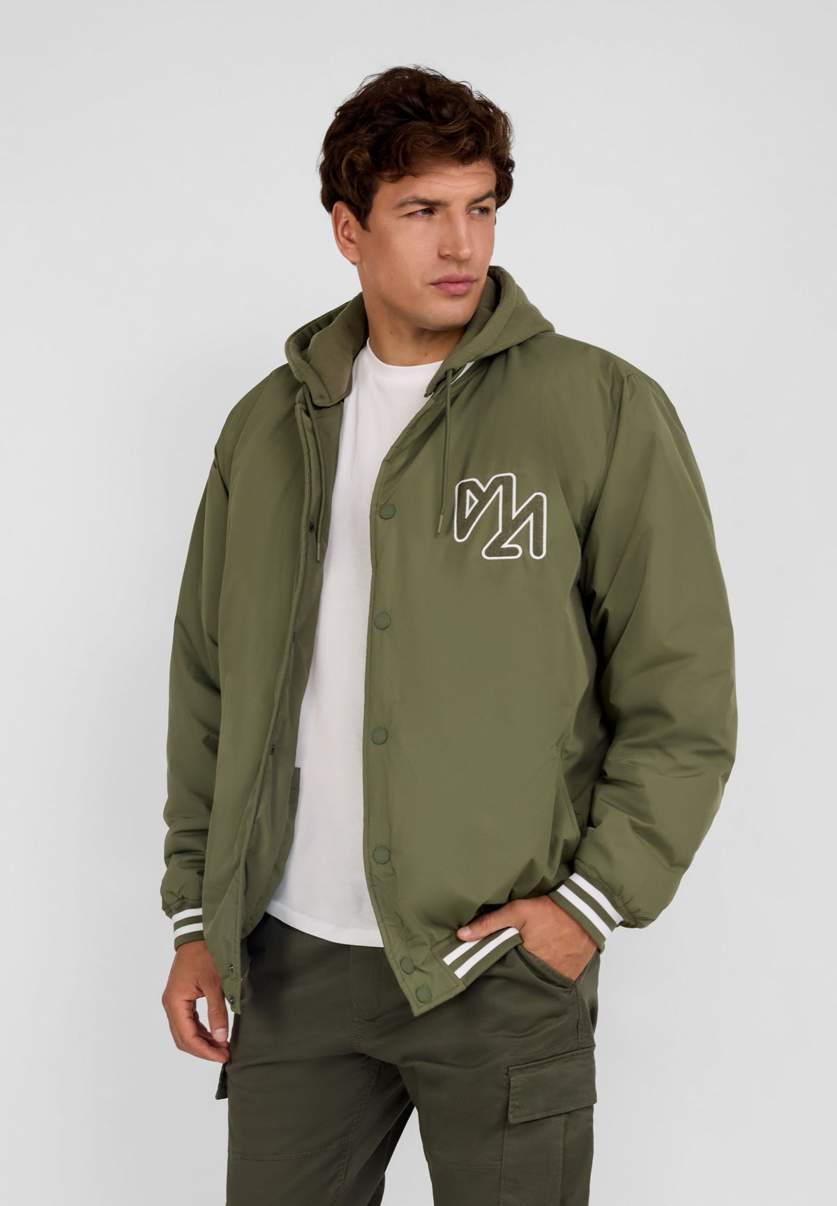 Men's khaki varsity jacket, shown worn.