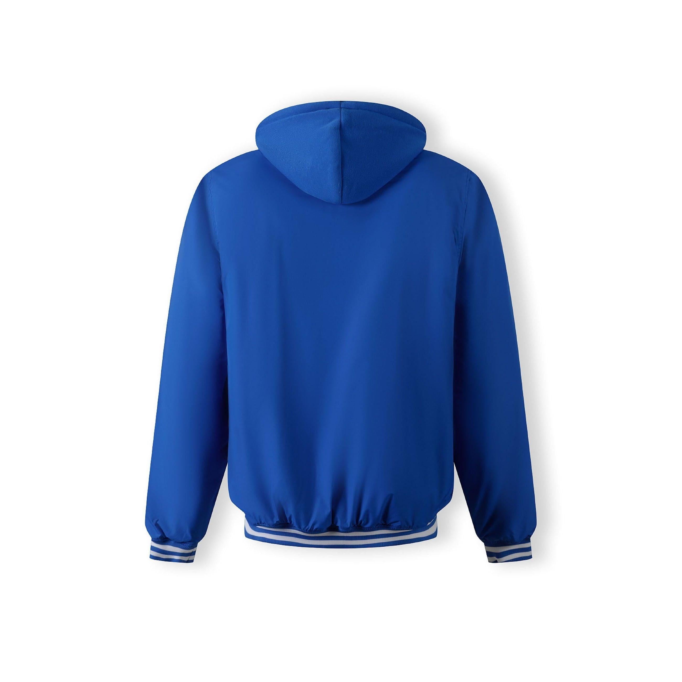 Close-up detail of cobalt blue jacket showing zip closure with matching blue zipper tape and snap button details