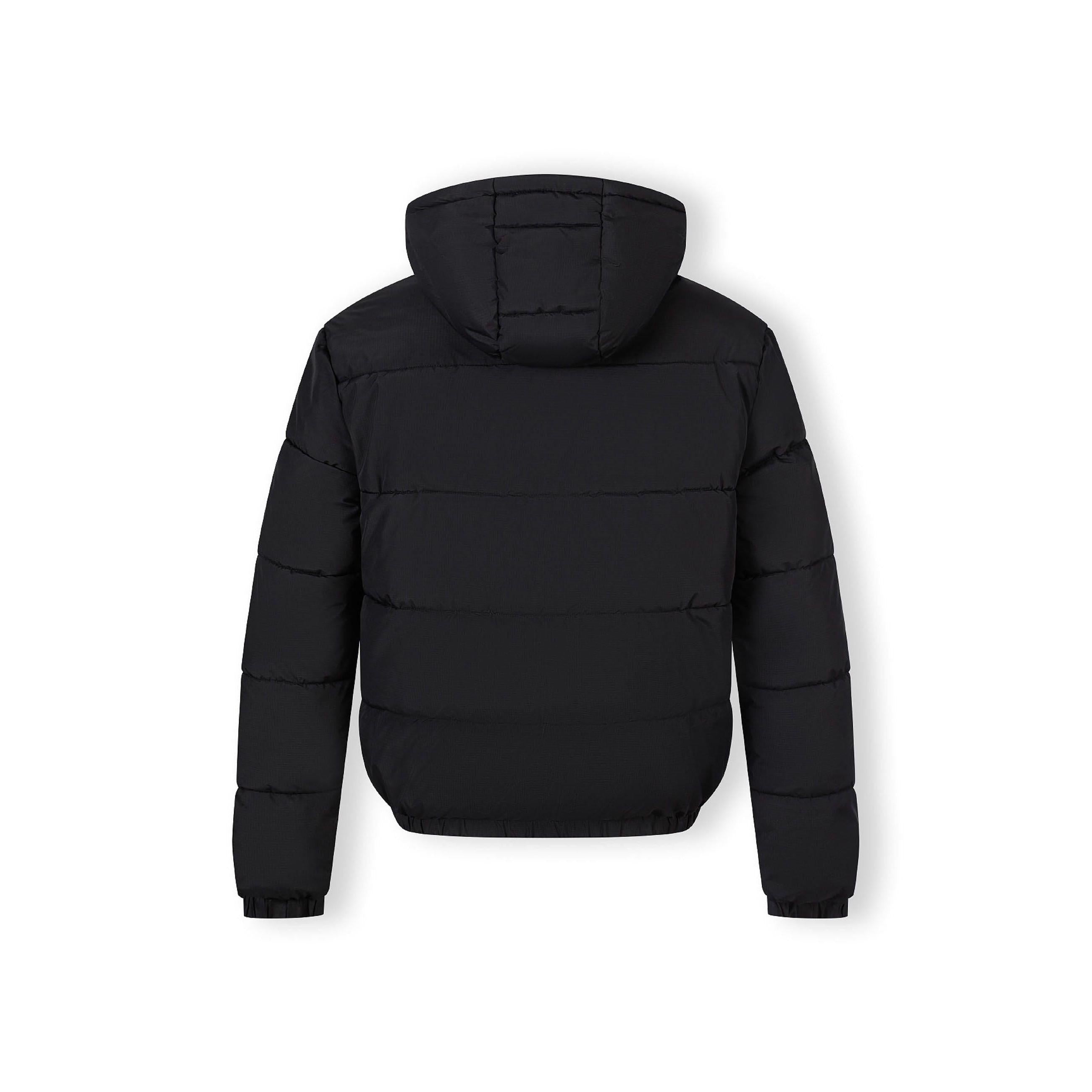 Close up detail of black fabric label patch on sleeve showing textured ripstop material