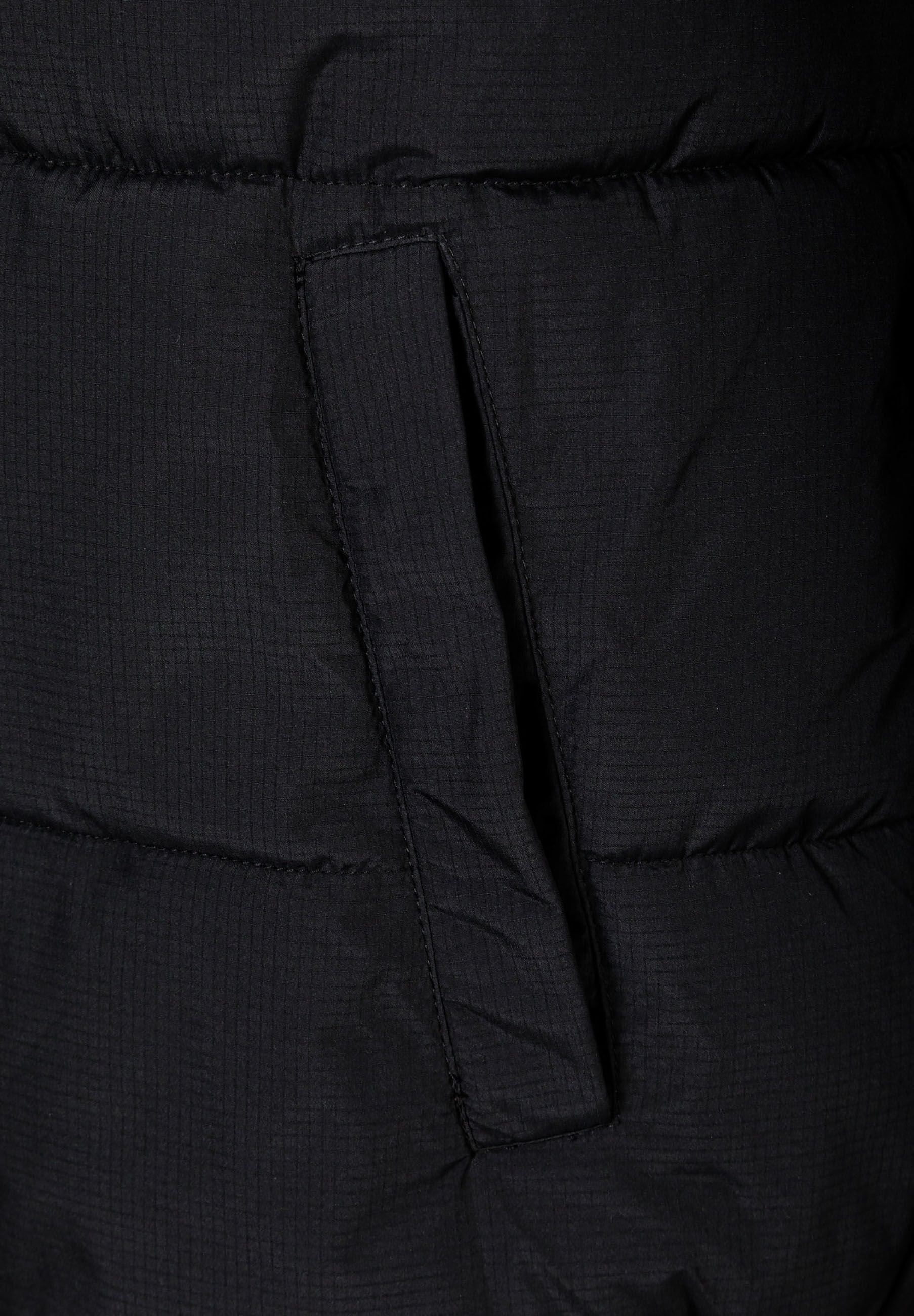 Close-up of a black ripstop jacket showing a zippered pocket and quilted texture.