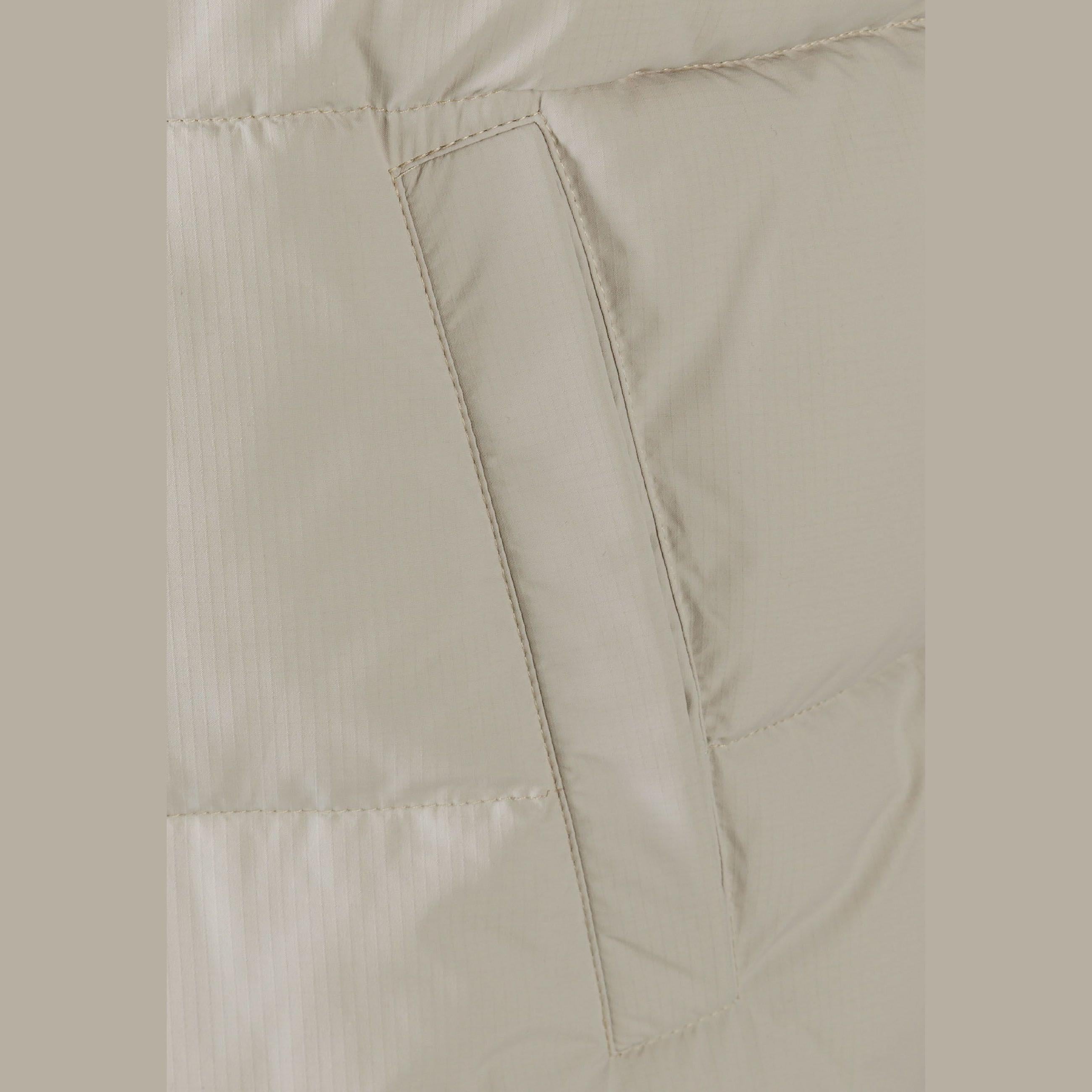 Close-up detail of grey gilet showing zip pocket construction with neat stitching and ripstop fabric texture