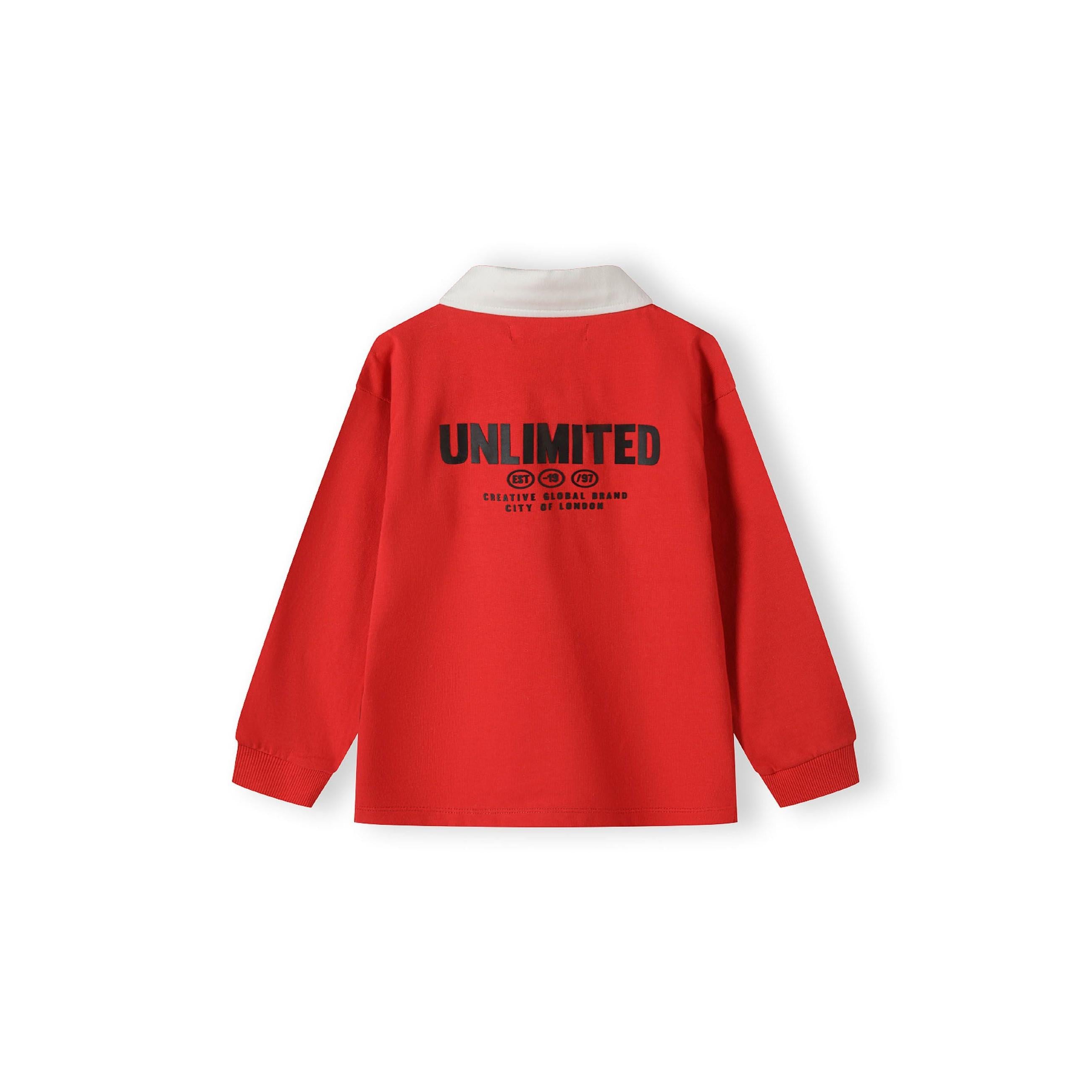 Back view of red long sleeve polo shirt displaying large 'Unlimited' text print with creative graphics branding on white background