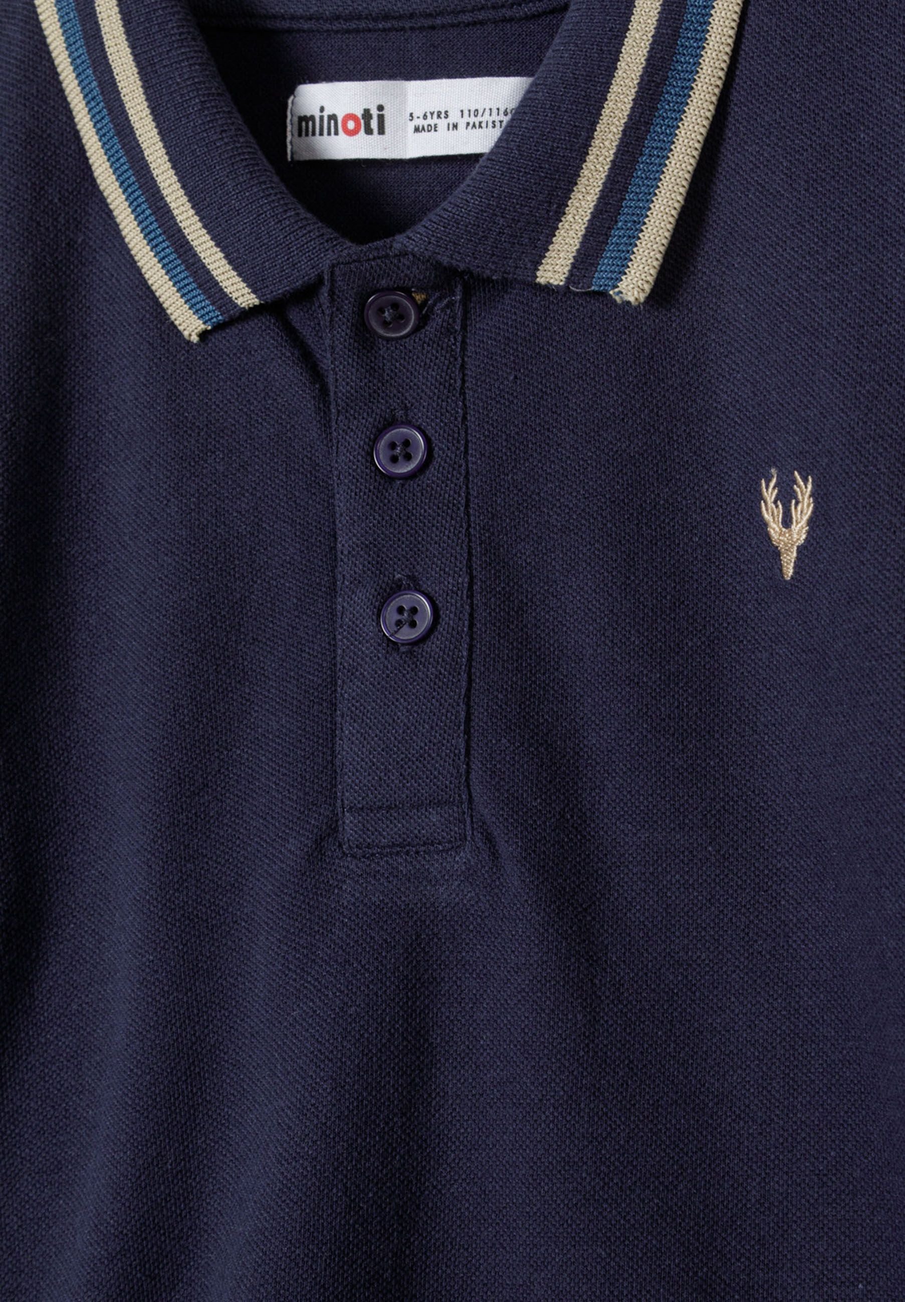 Detail of a navy long sleeve polo top with a contrast collar and button placket.