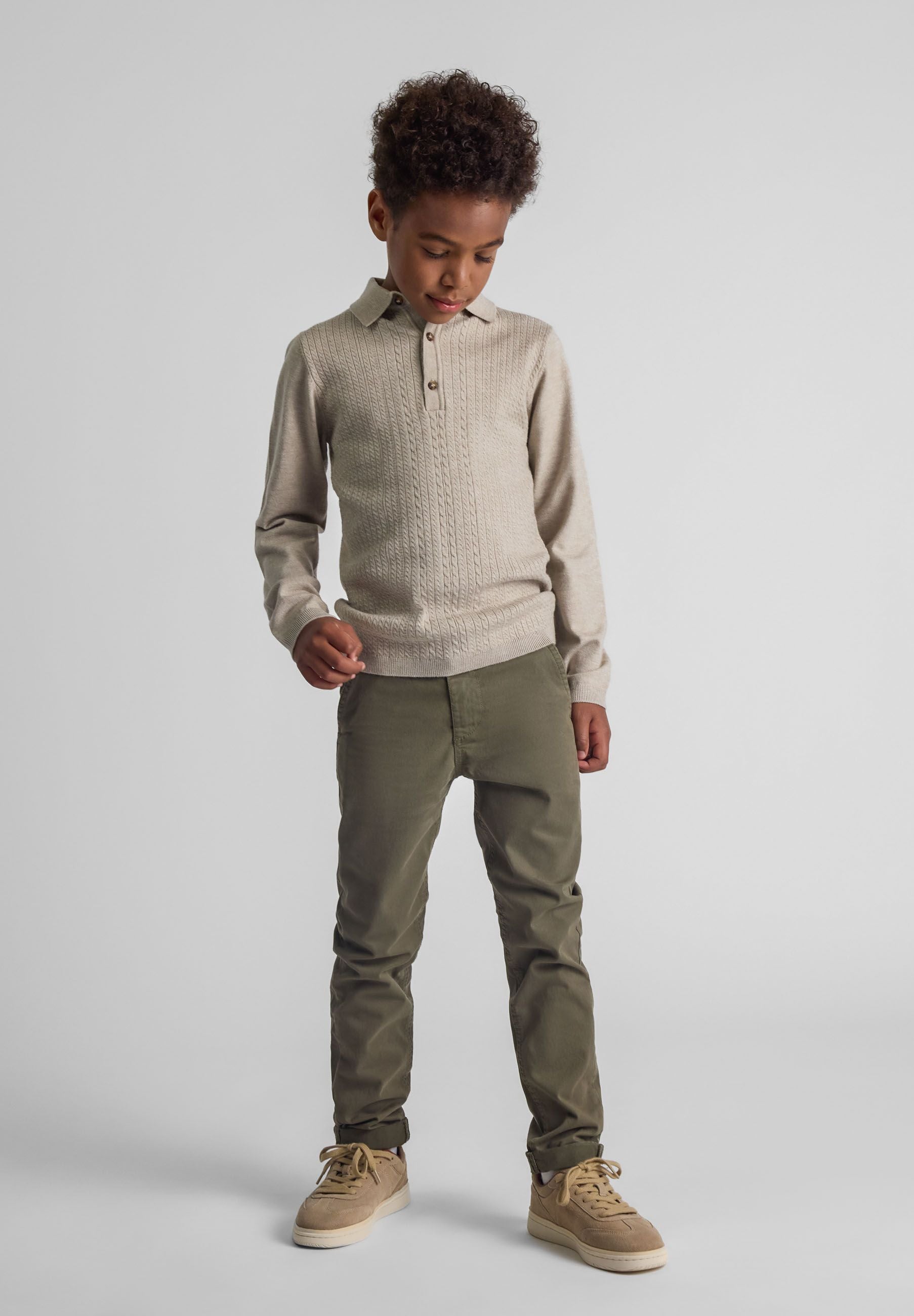 Boys khaki chino trousers, front view with pockets and ankle cuffs.