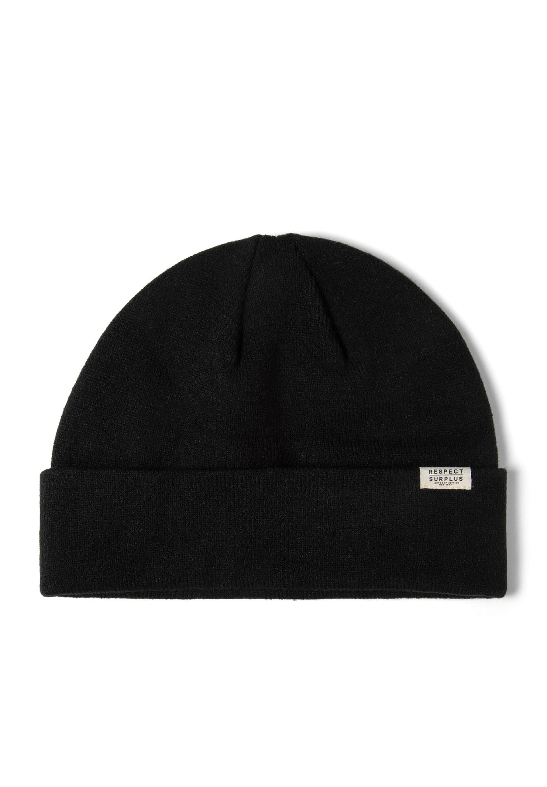 Close-up of a black ribbed beanie hat with a fold-up cuff and a small badge.