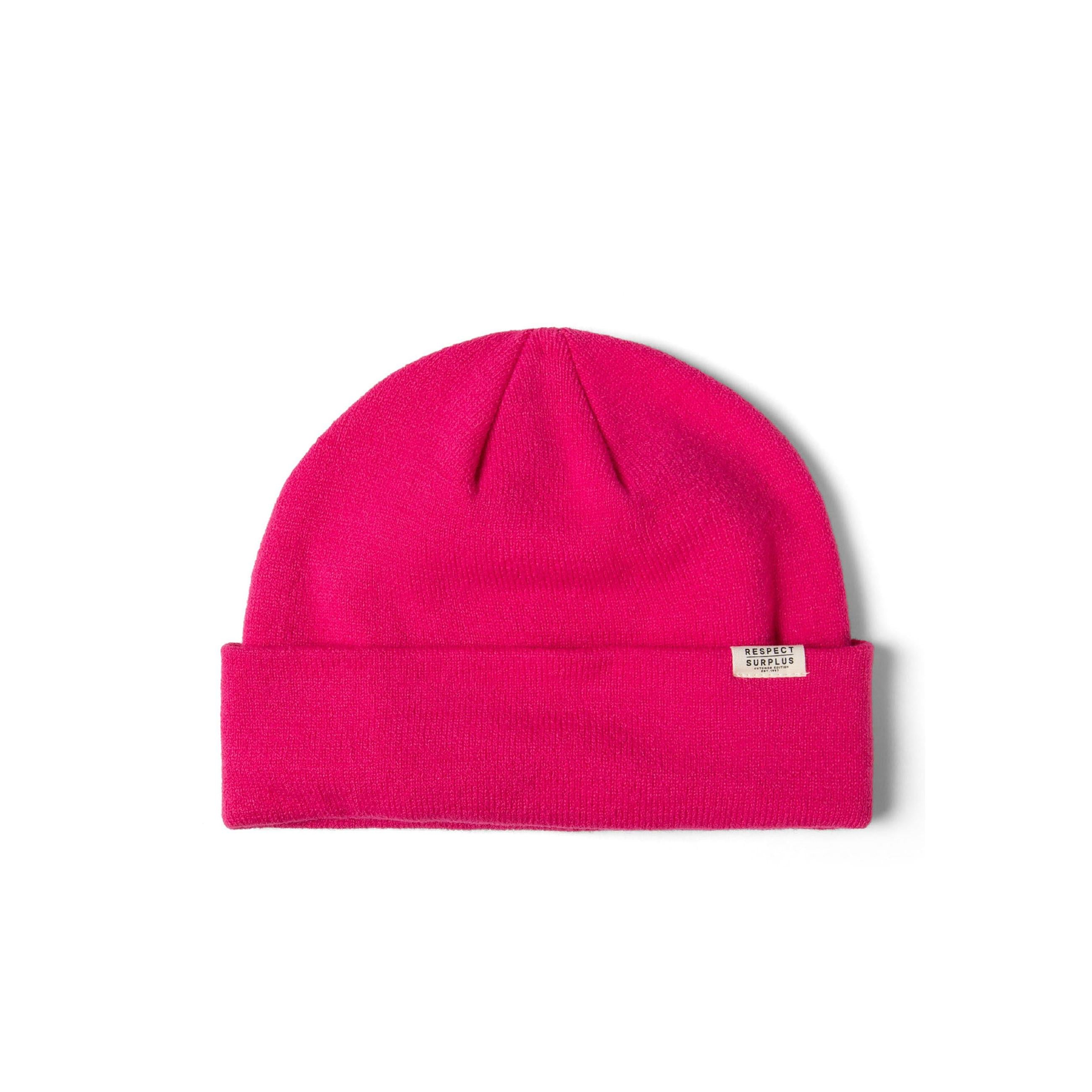 Close-up side view of bright pink ribbed beanie hat showing knit texture and Respect Surplus label