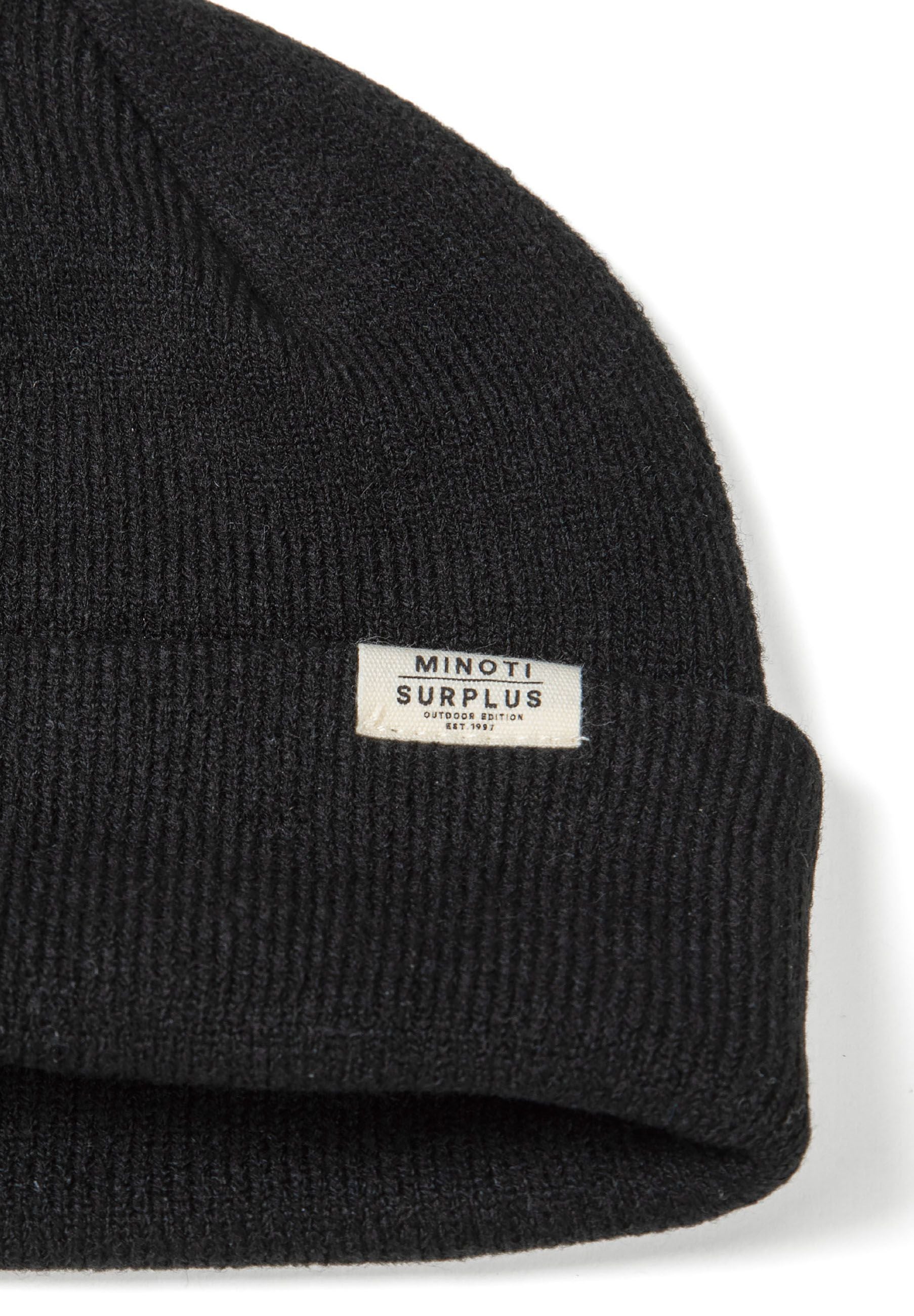 Detail of a black ribbed beanie hat with a folded brim and a small logo badge.