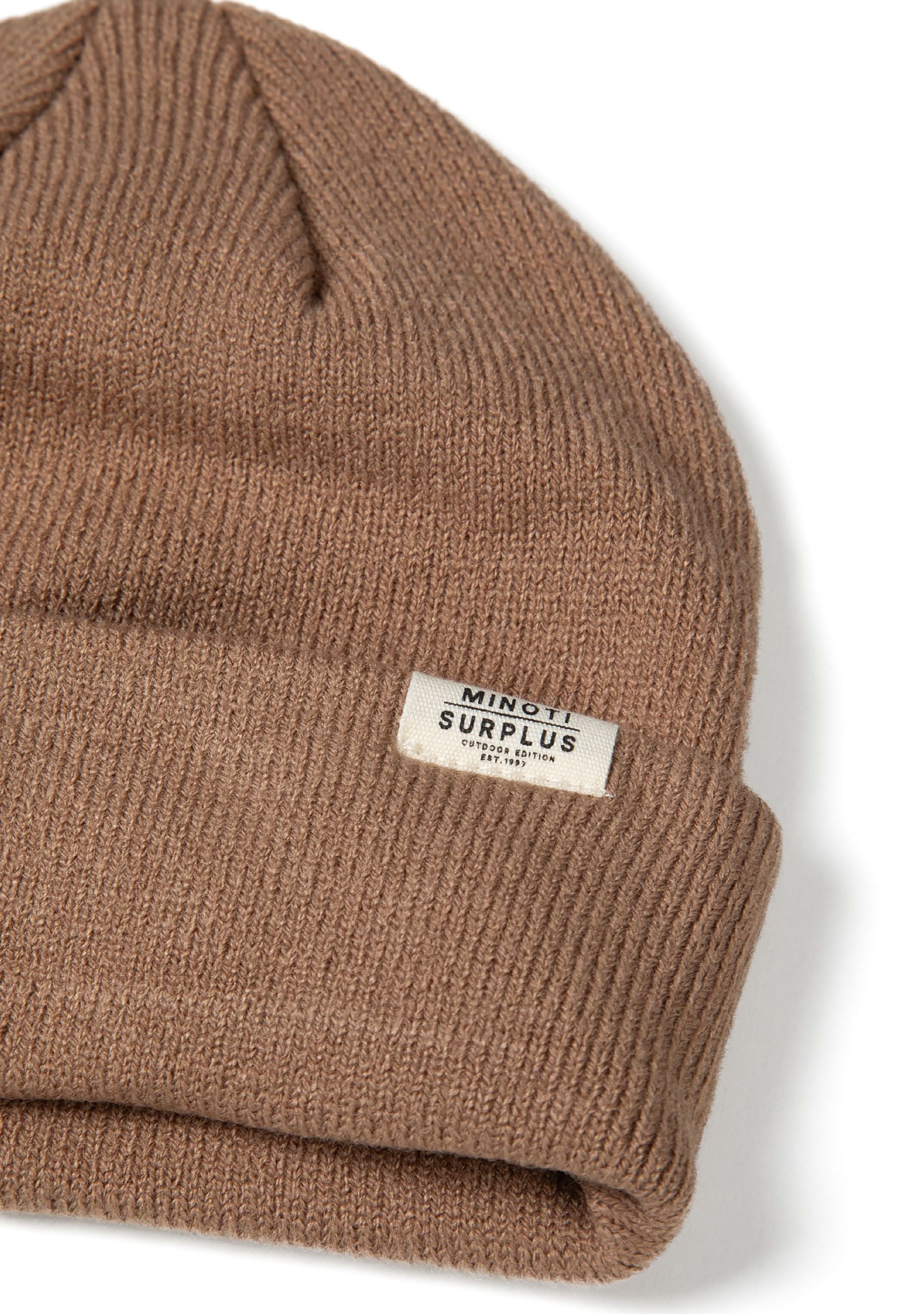 Detail of a ribbed beanie hat in brown with a fold-up cuff and a small logo badge.