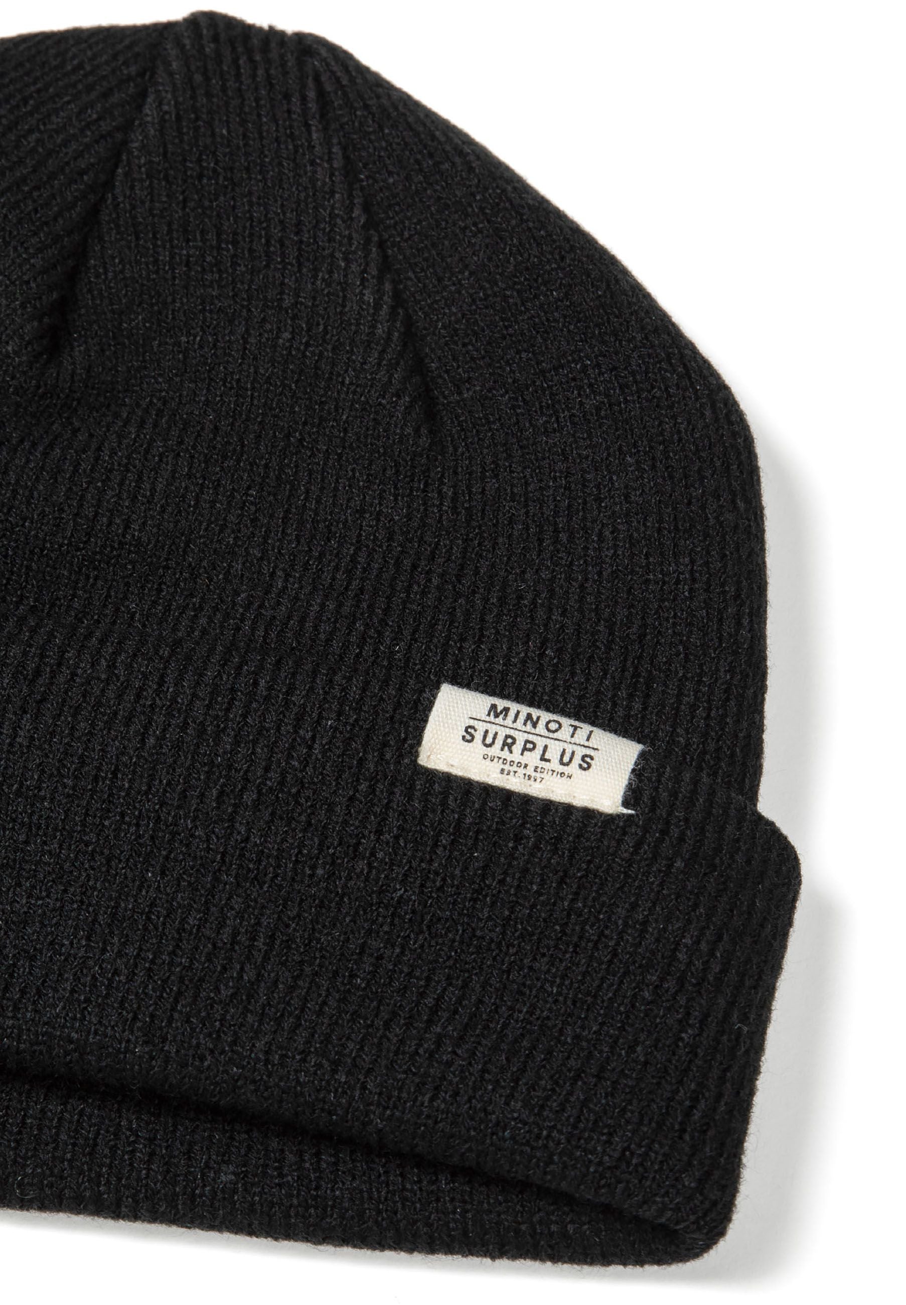 Detail of a black ribbed beanie hat with a fold-up cuff and a small logo badge.