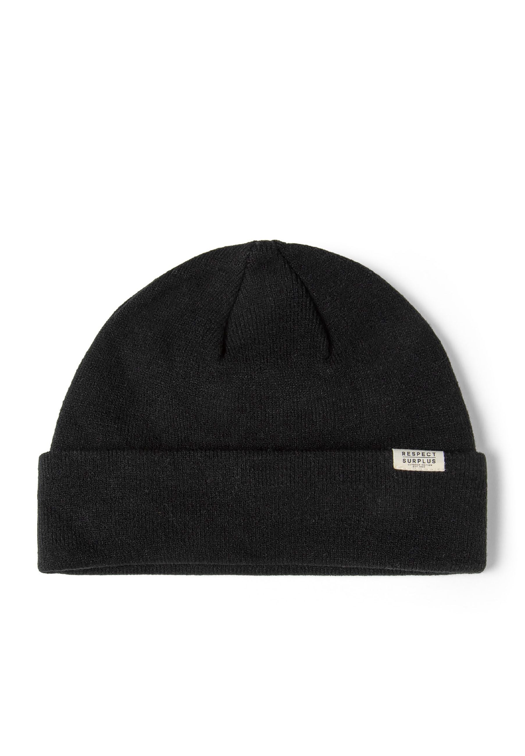 Close-up of a black ribbed beanie hat with a cuff and a subtle badge.
