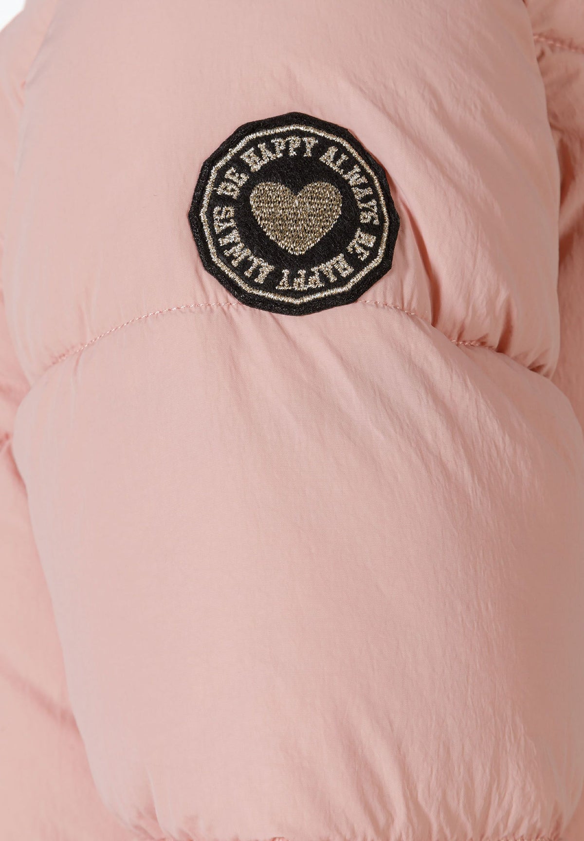 Close-up of the sleeve patch on the pink long puffer coat.