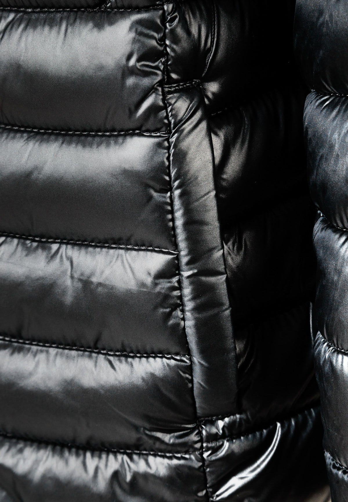 Close-up of the pocket on the black puffer jacket.