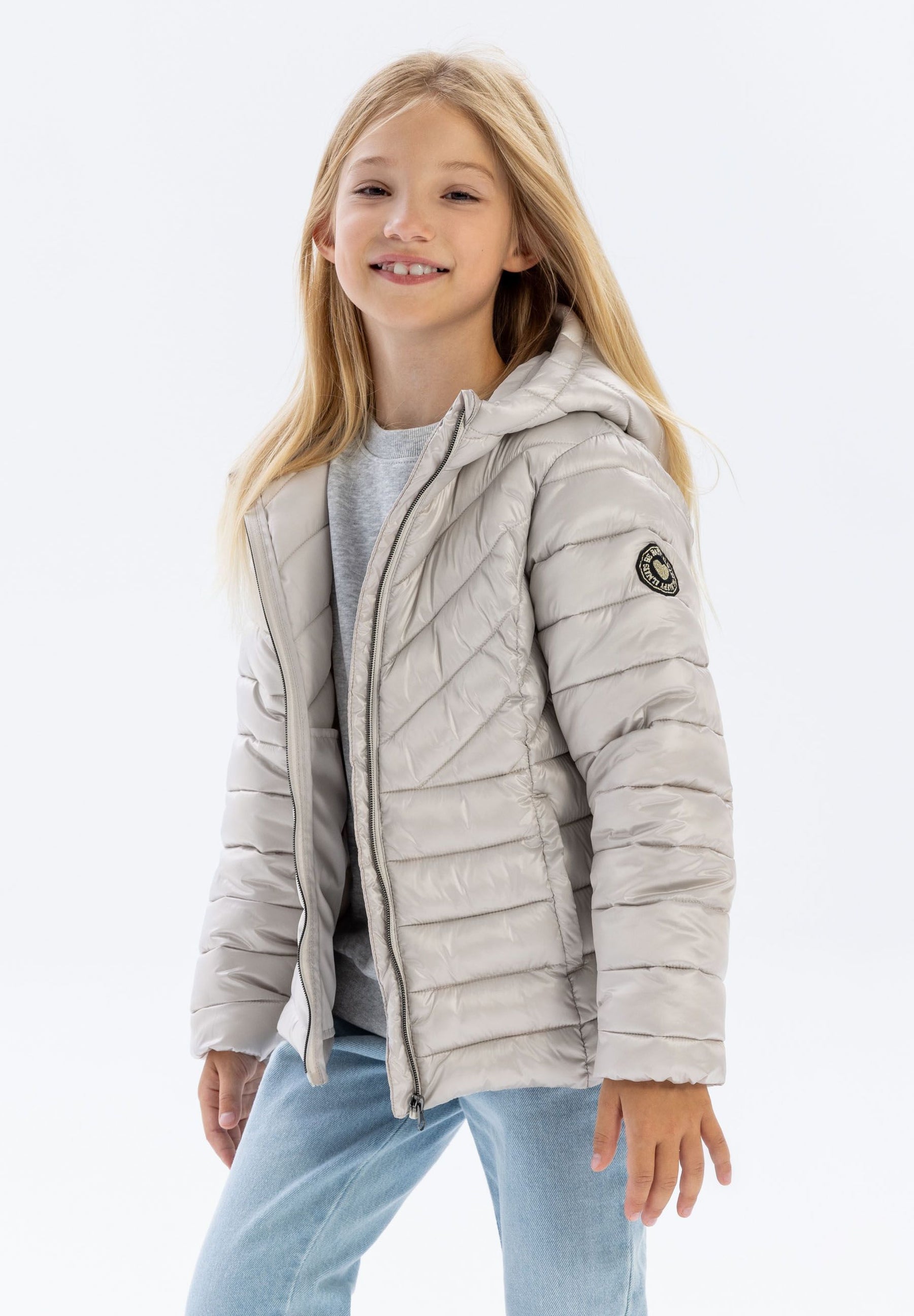Girls quilted jacket in grey, front view, featuring a hood and a heart-shaped badge.