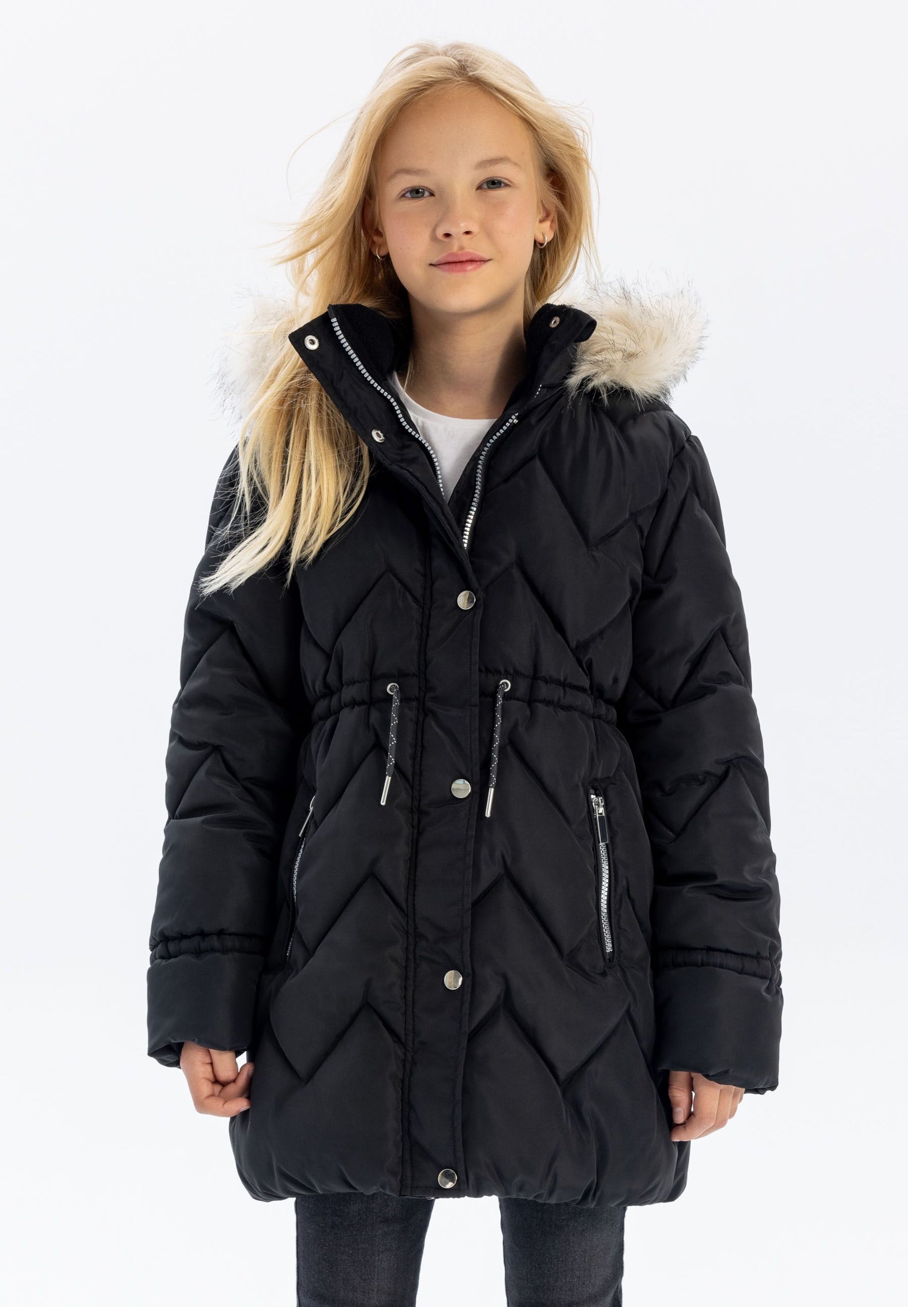 Girls mid-length black quilted winter jacket with faux fur hood, front view, features zippered pockets.
