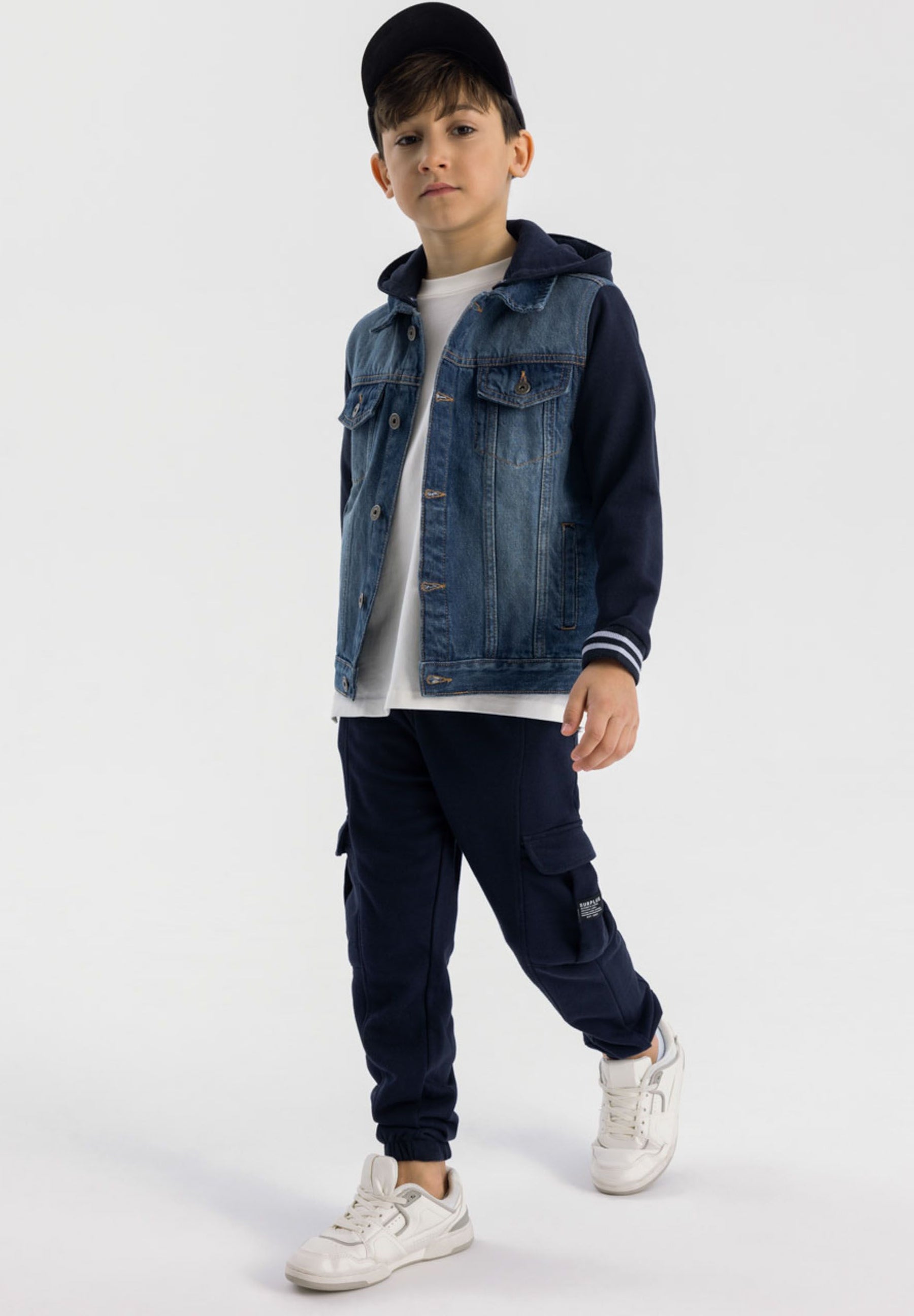 Boys denim jacket with detachable hood, front view, featuring fleece sleeves and chest pockets.
